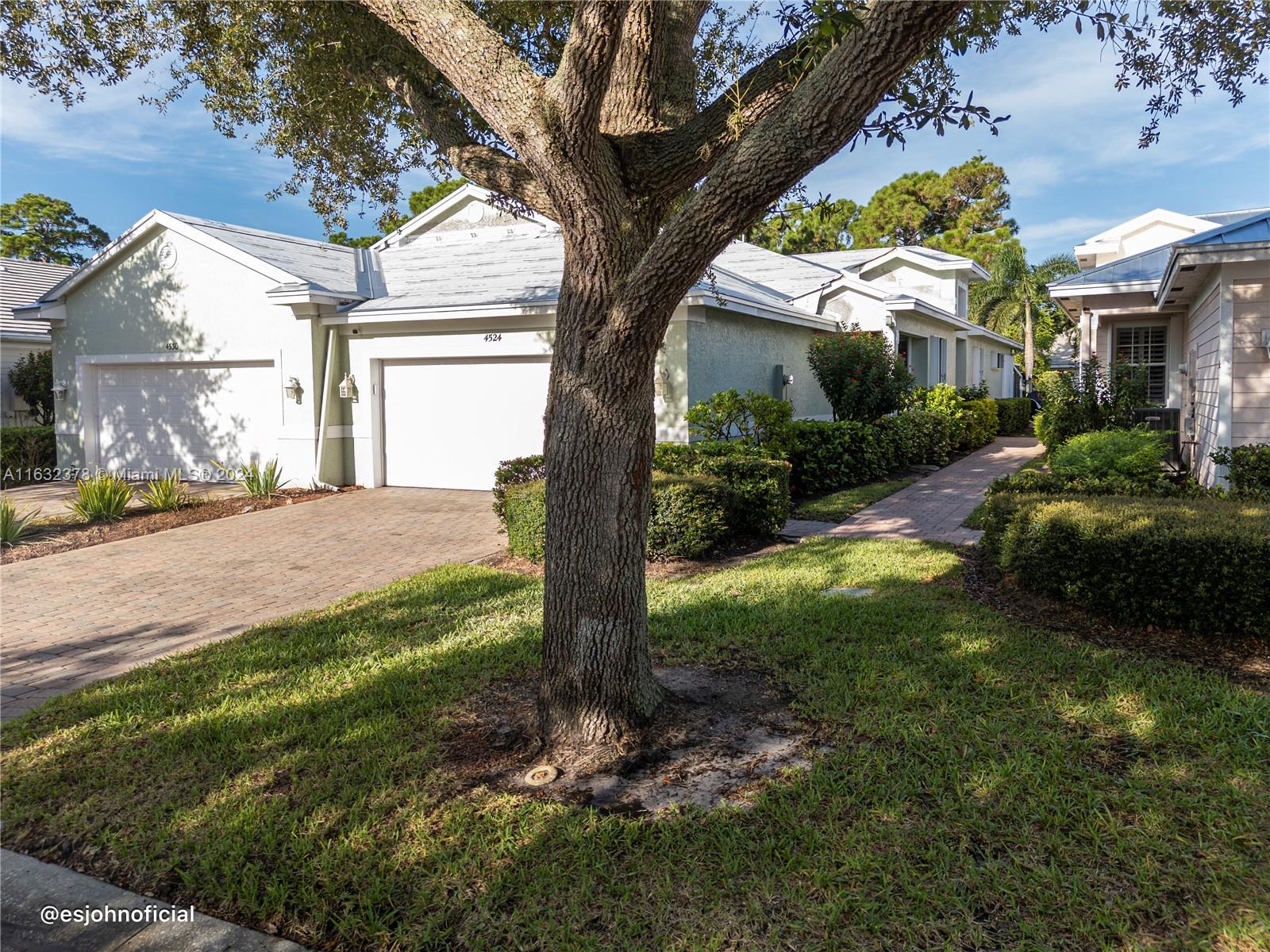 a view of a house with a tree in a yard