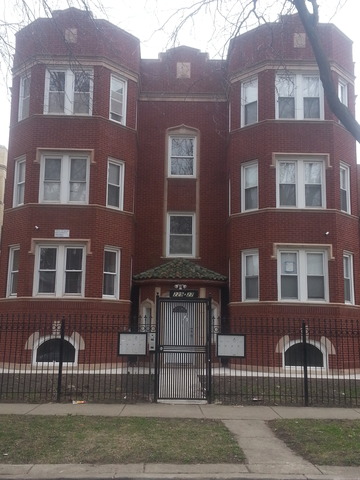 a front view of a residential apartment building with a yard