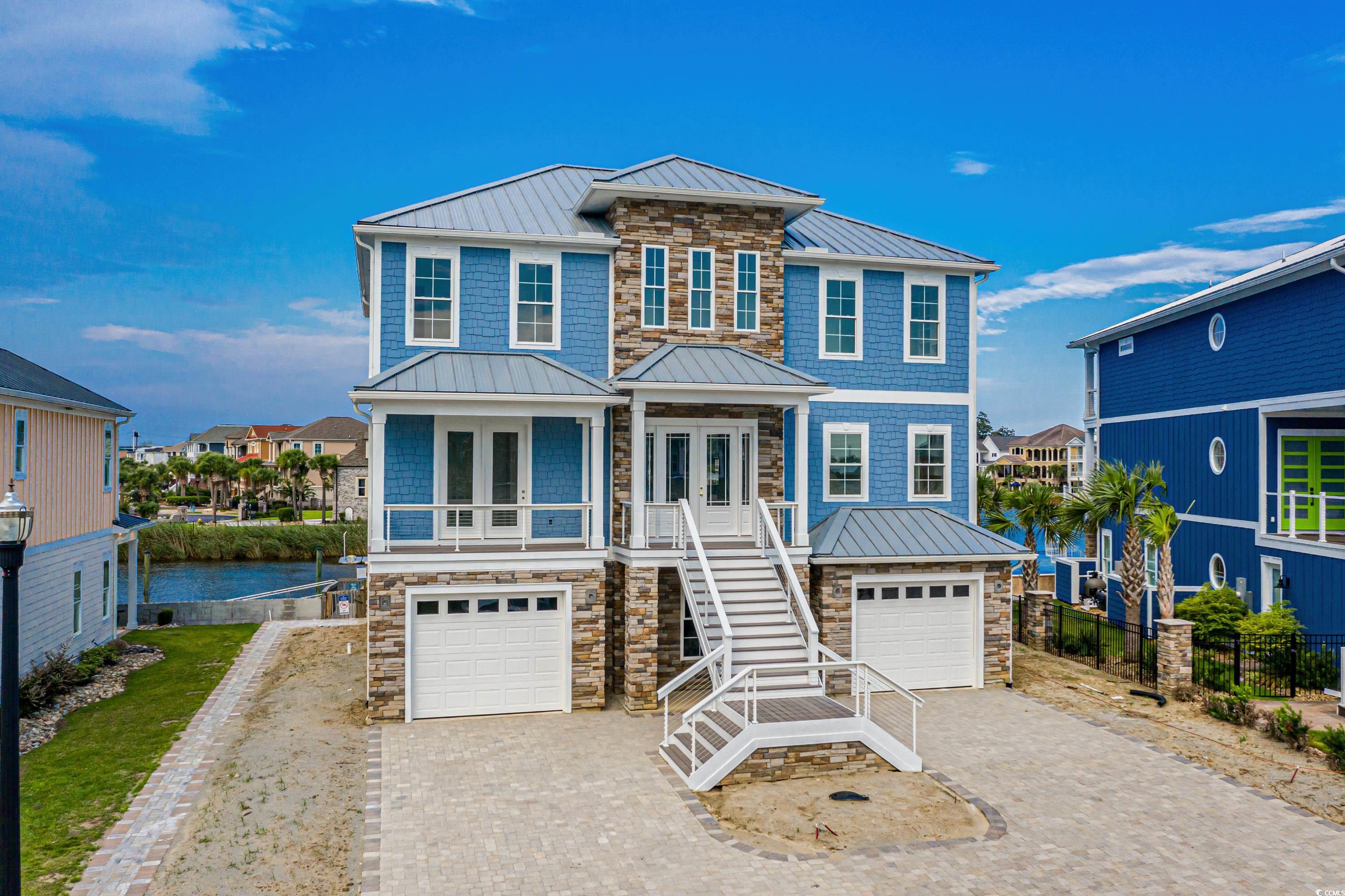 View of front of house featuring a garage, a water