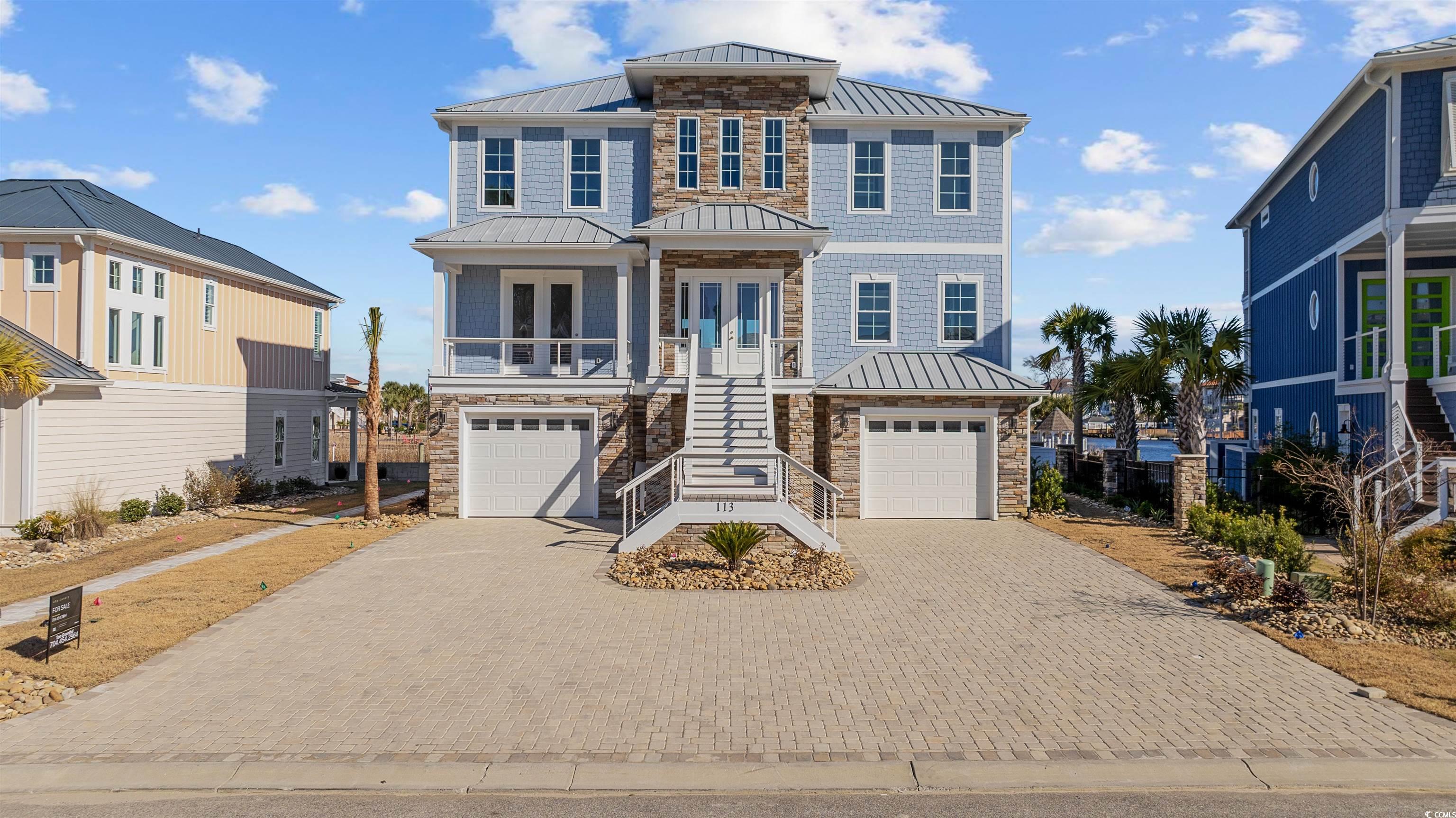 View of front of house featuring a garage, covered