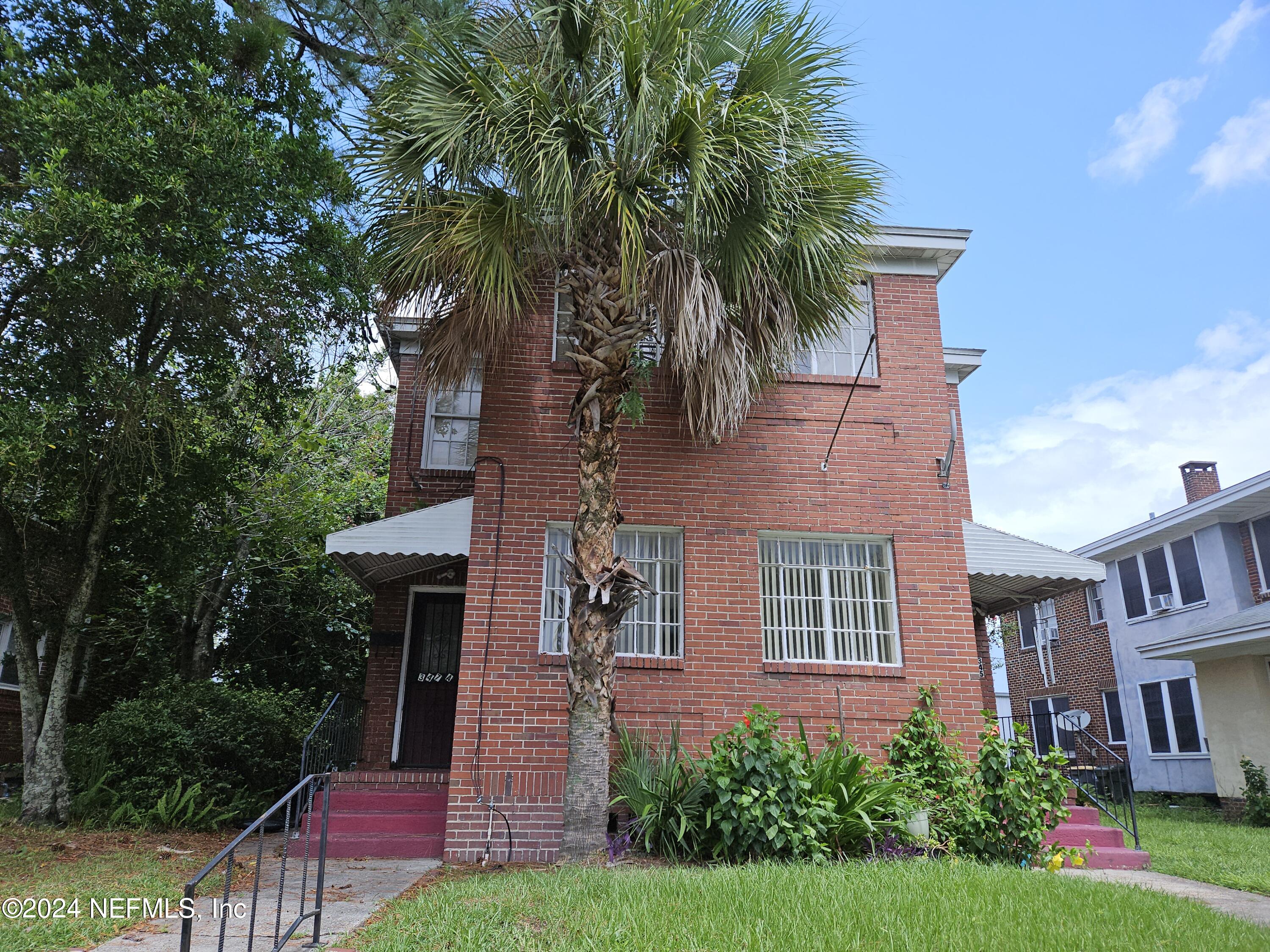 a front view of a house with a garden