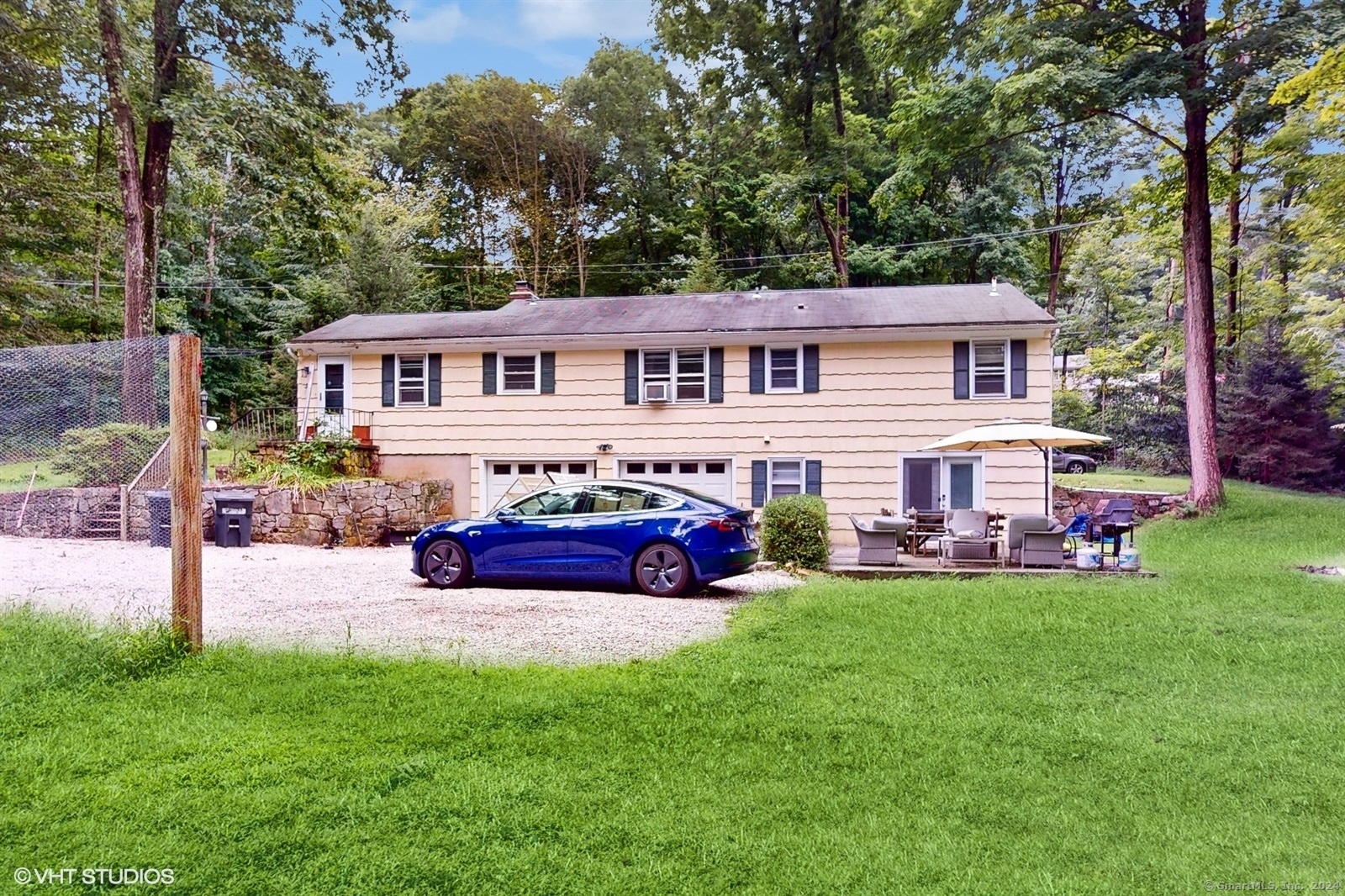 a view of a house with a yard and sitting area