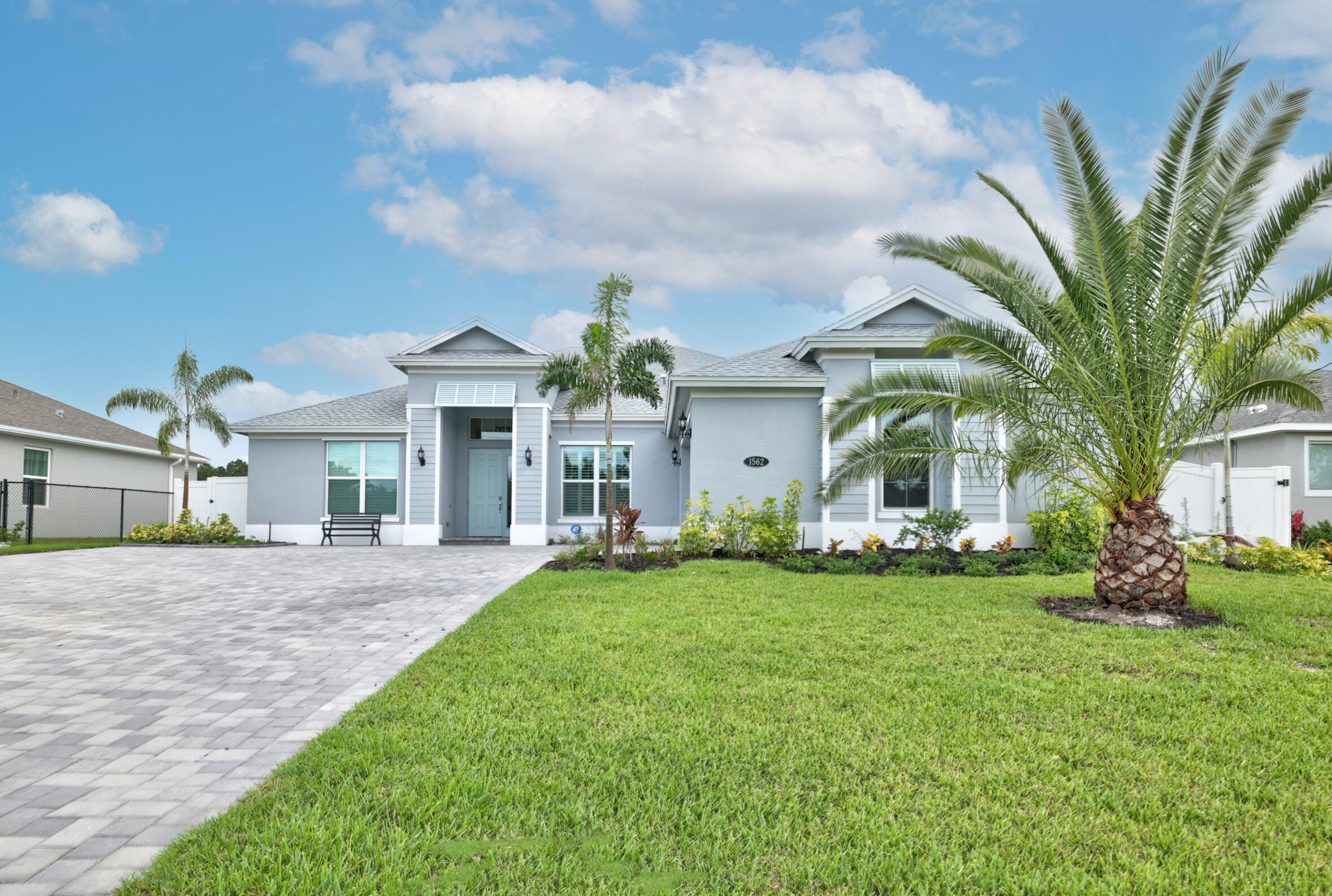 a front view of house with yard and green space