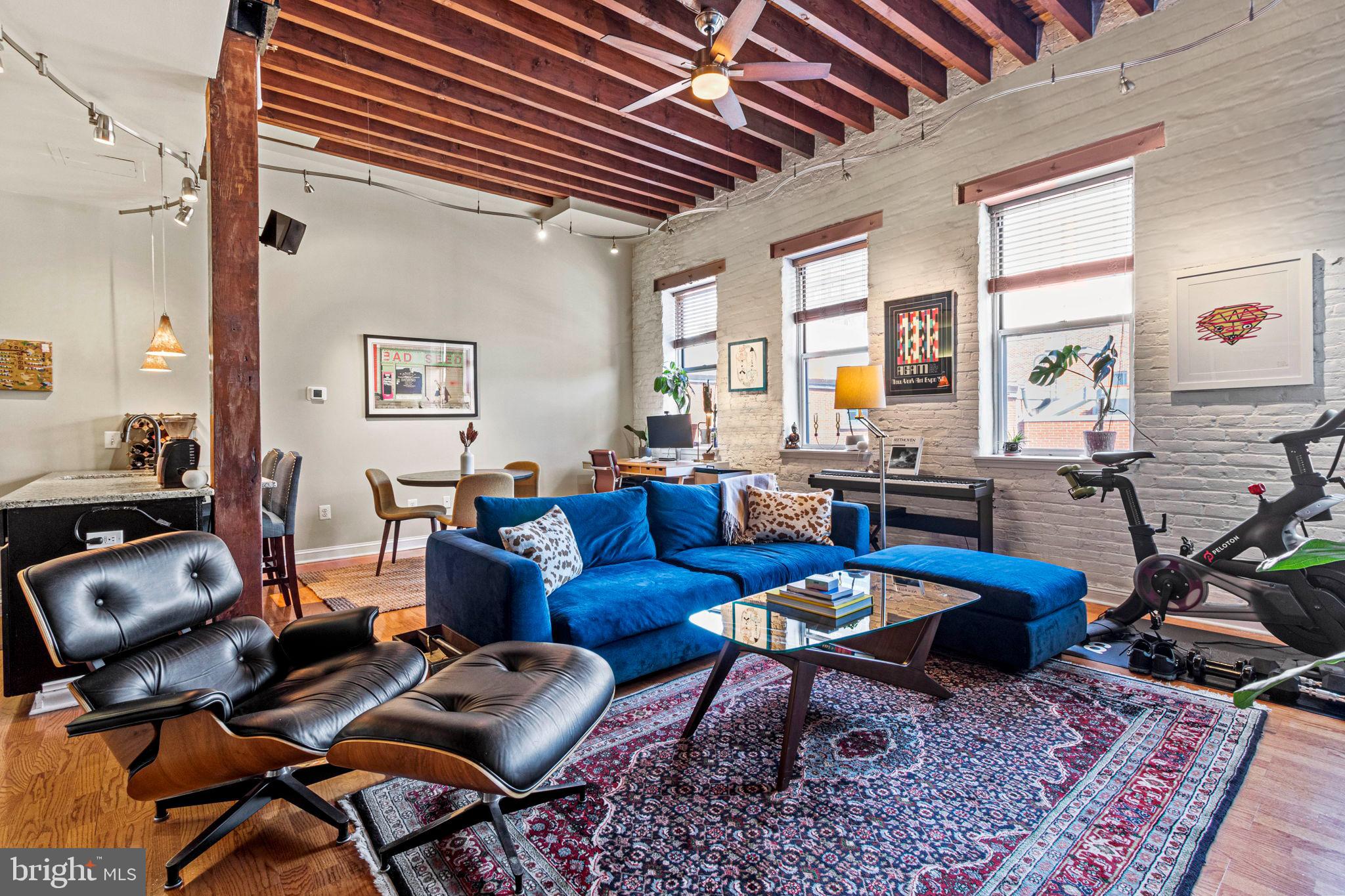 a living room with furniture and wooden floor