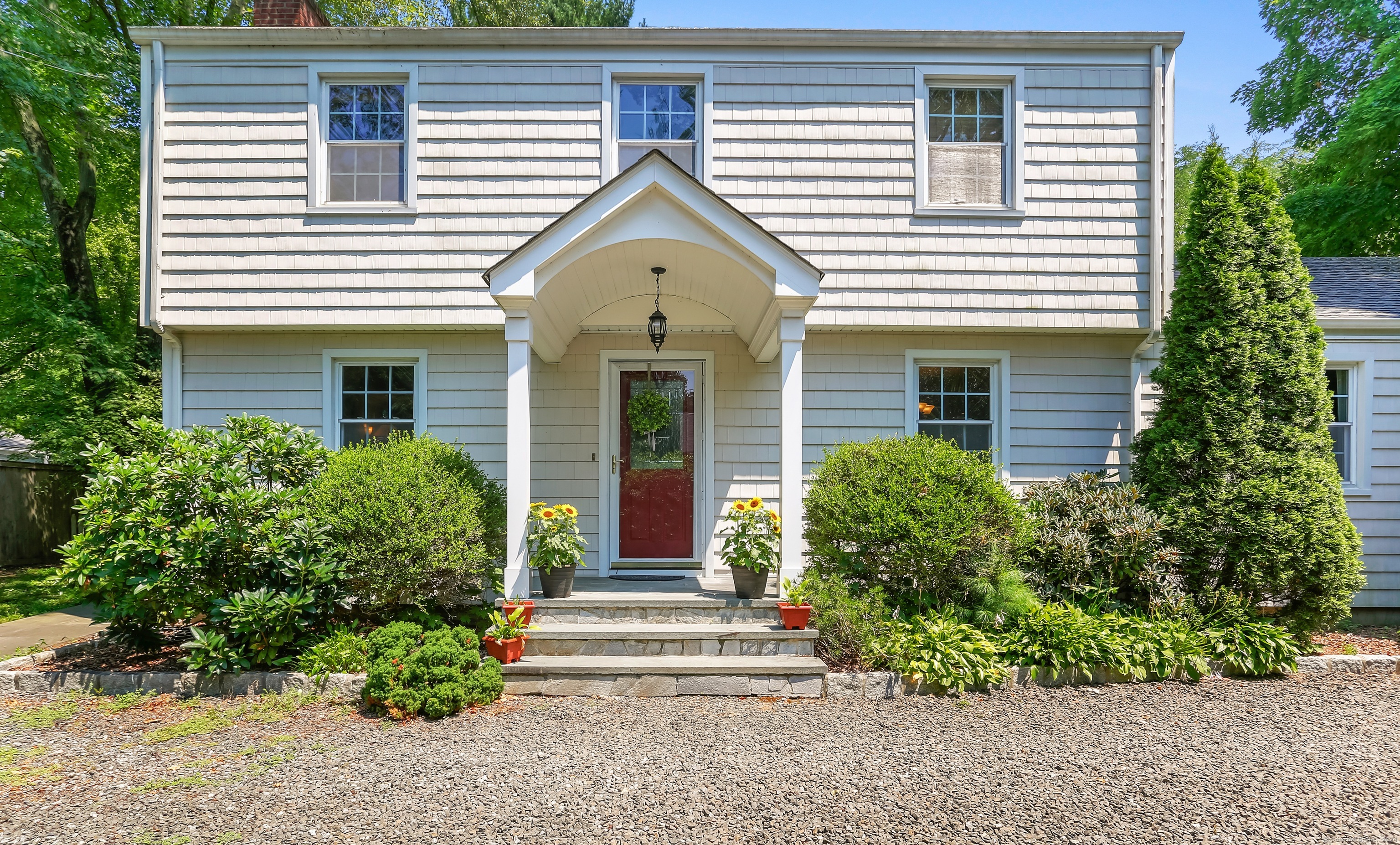 a view of a house with a small yard and plants