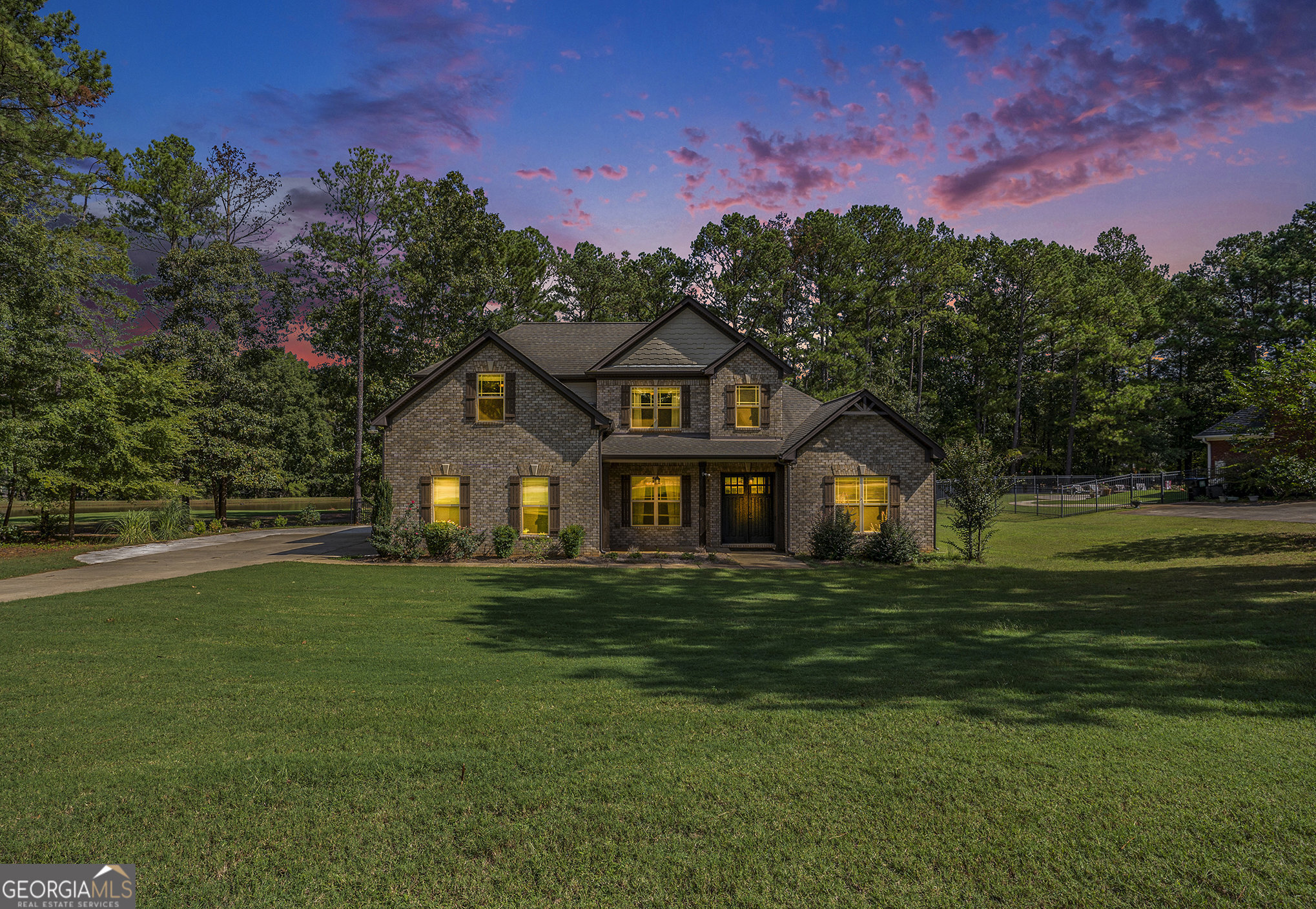 a front view of a house with a garden