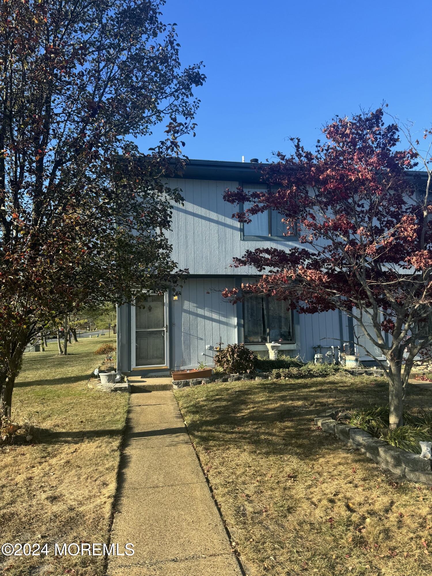 a front view of a building with a yard