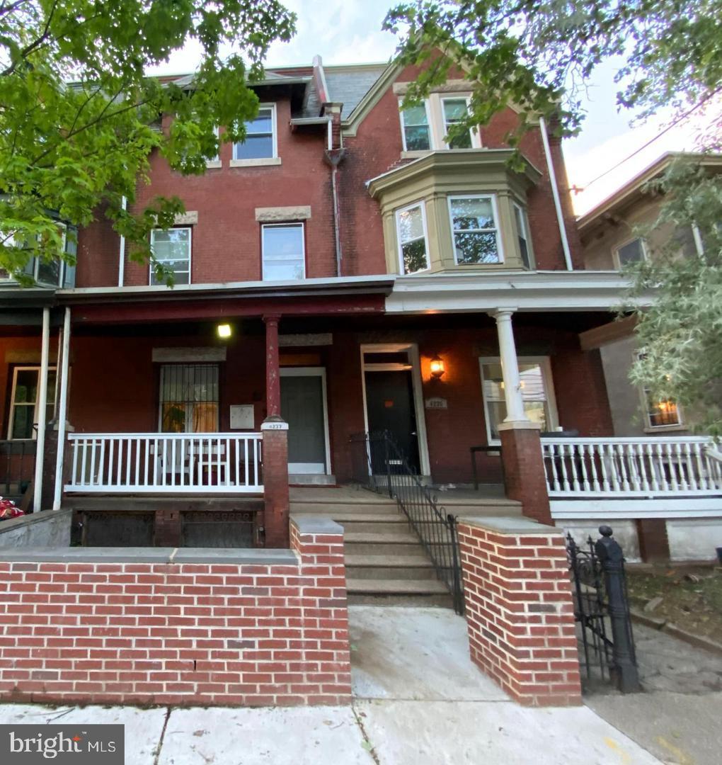 front view of a house with a bench