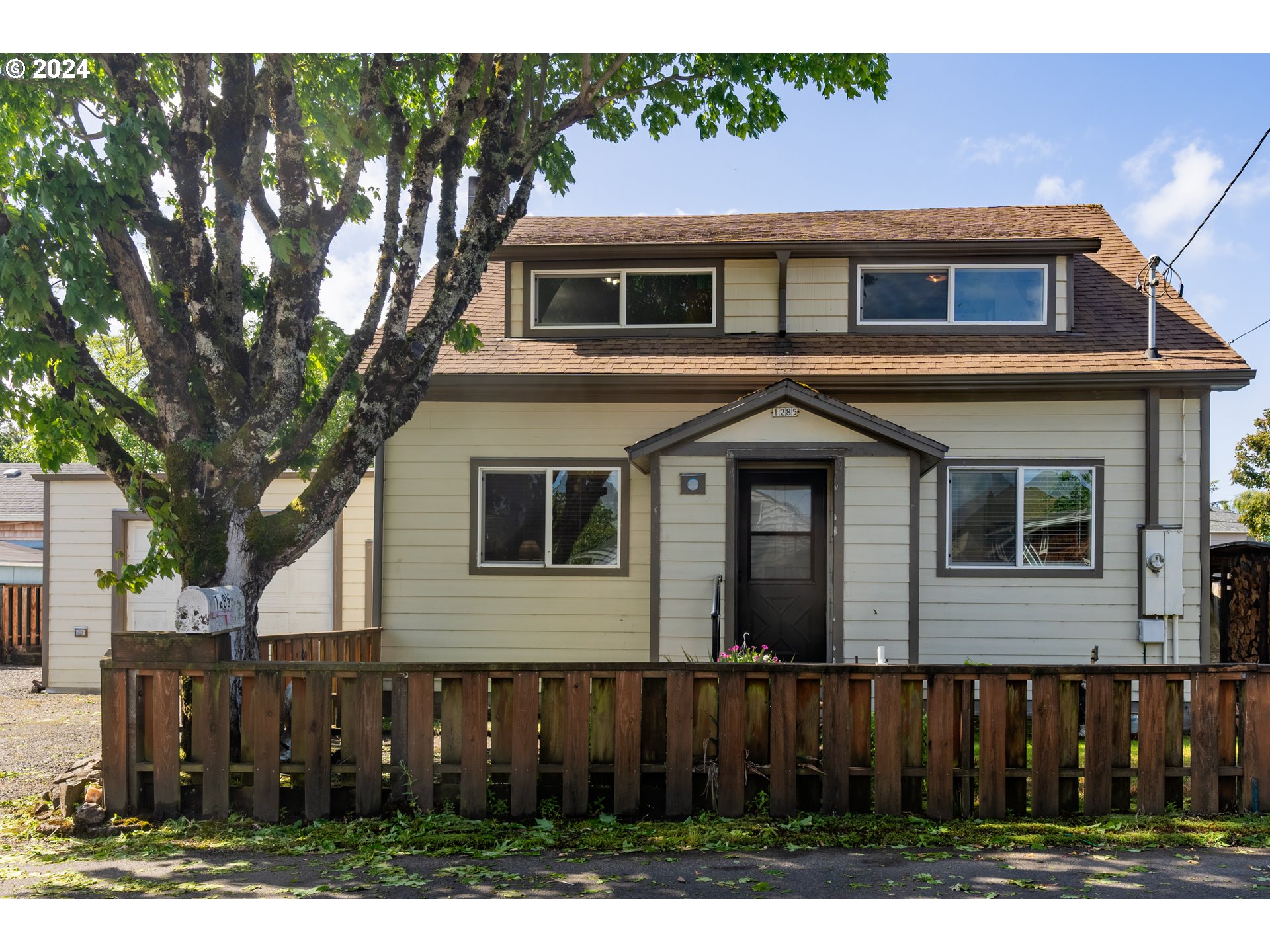 a front view of a house with wooden fence