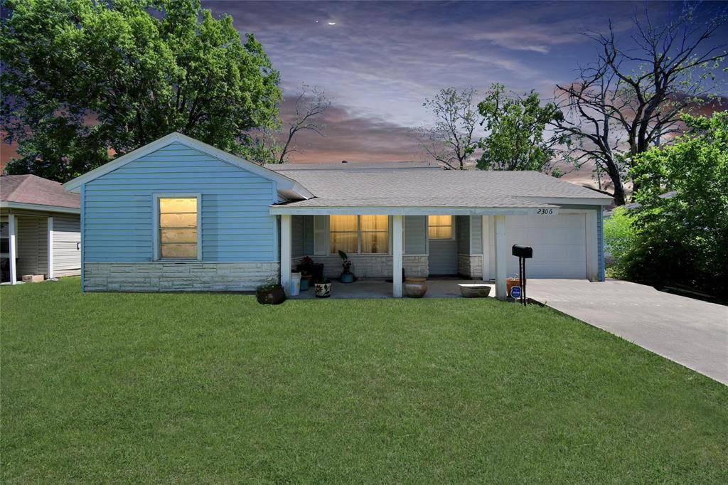 a view of a house with a yard and sitting area