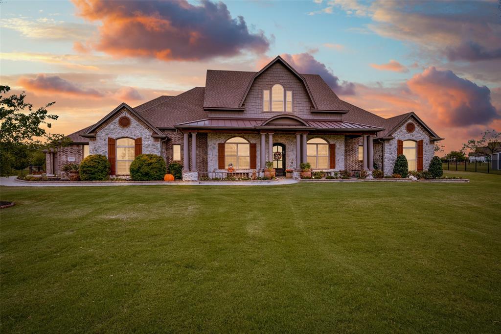 View of front of home featuring a lawn