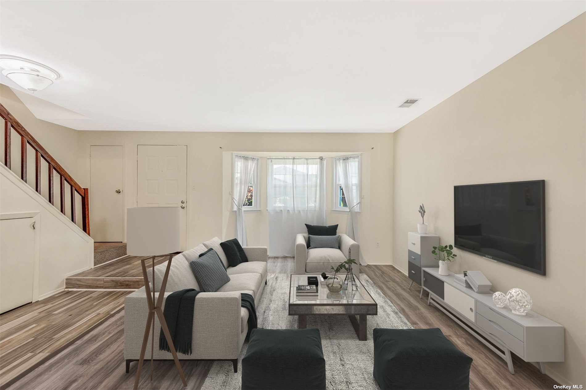 a living room with furniture and a flat screen tv