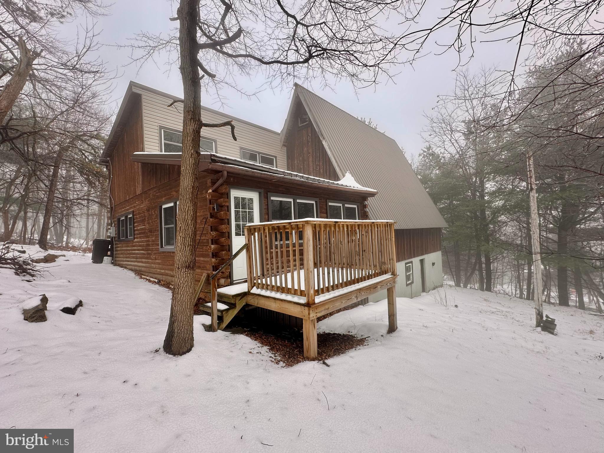 a view of house with a snow in a backyard