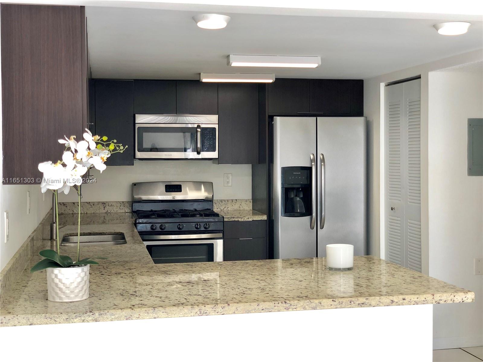 a kitchen with a refrigerator and a sink