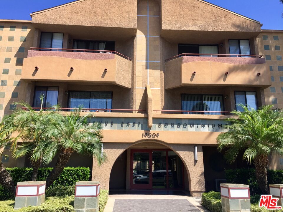 a front view of a building with garden