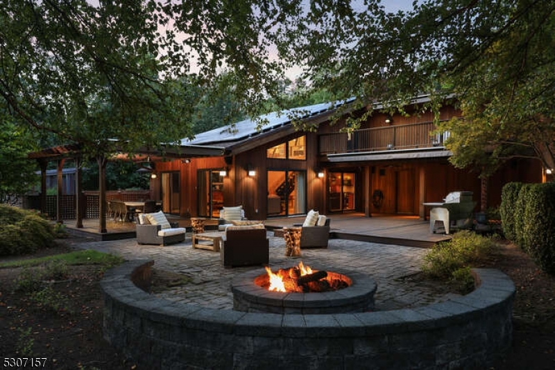 a view of a house with backyard and sitting area