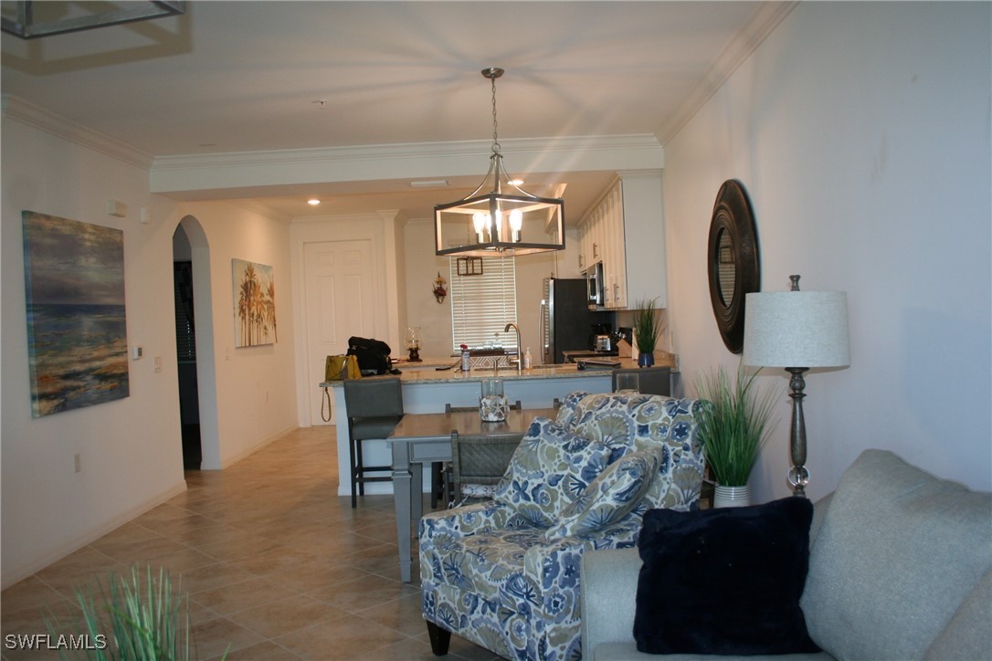 a living room with furniture a window and a chandelier