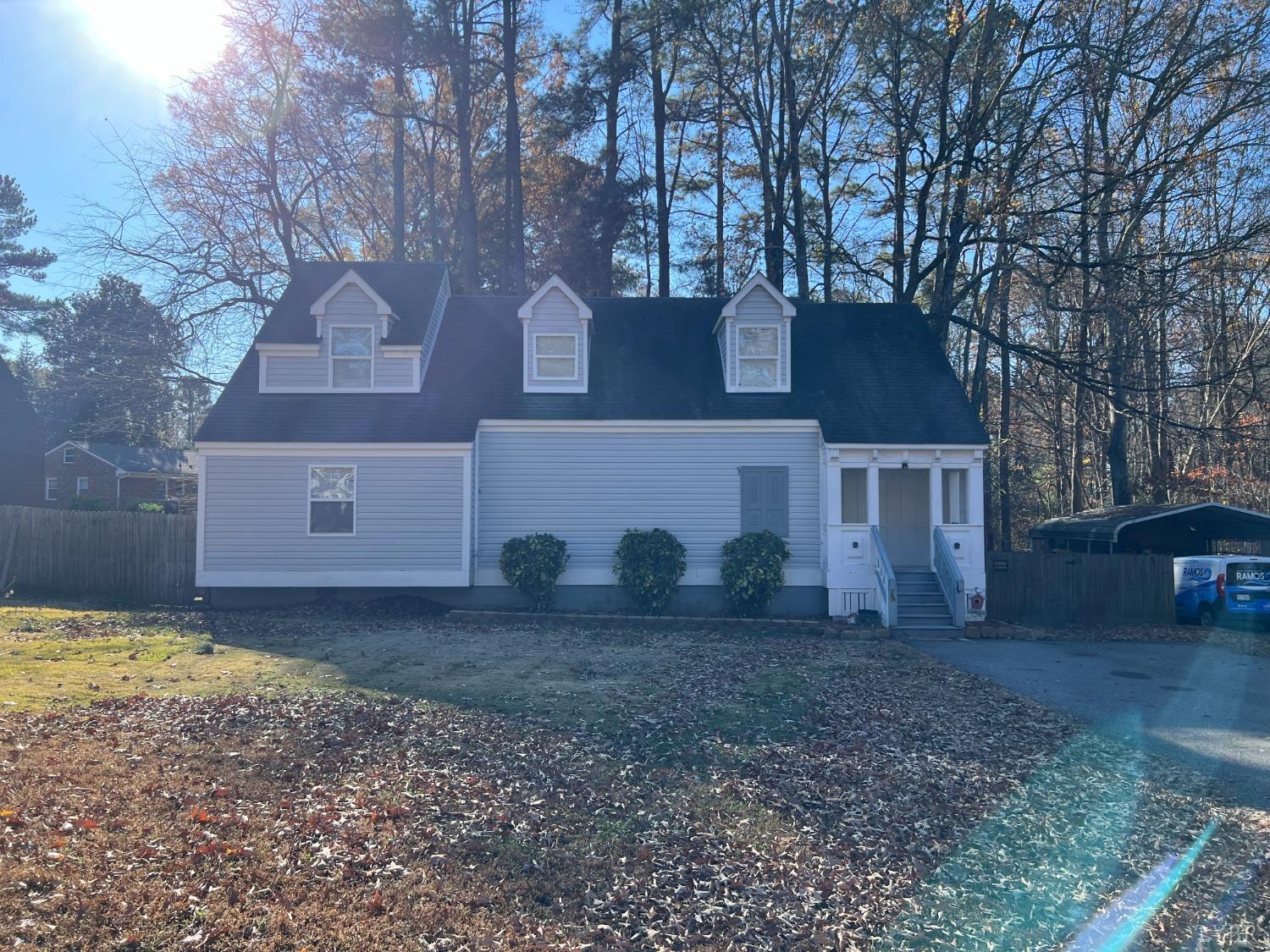 a house that has a tree in front of it