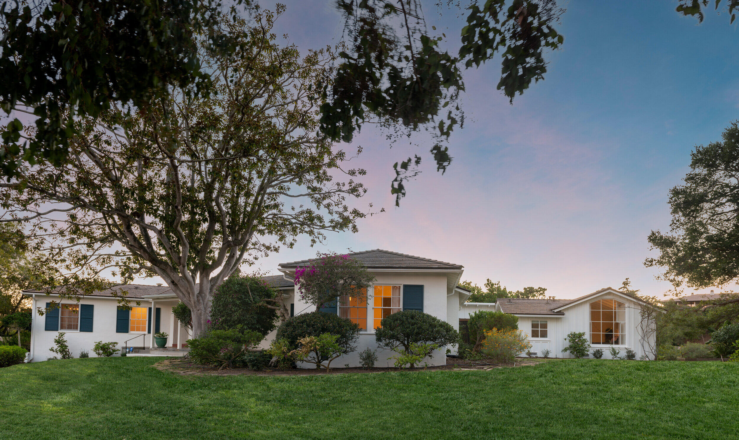 a front view of a house with a garden