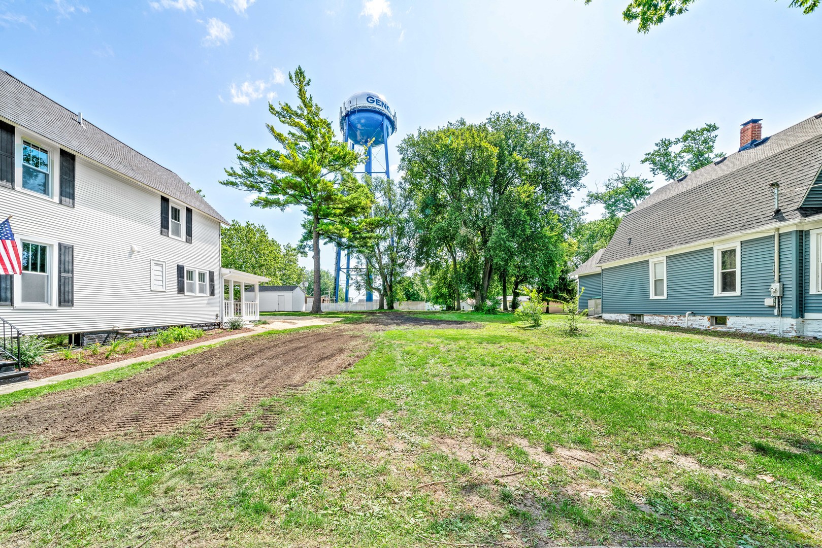 a front view of a house with a yard and a garage