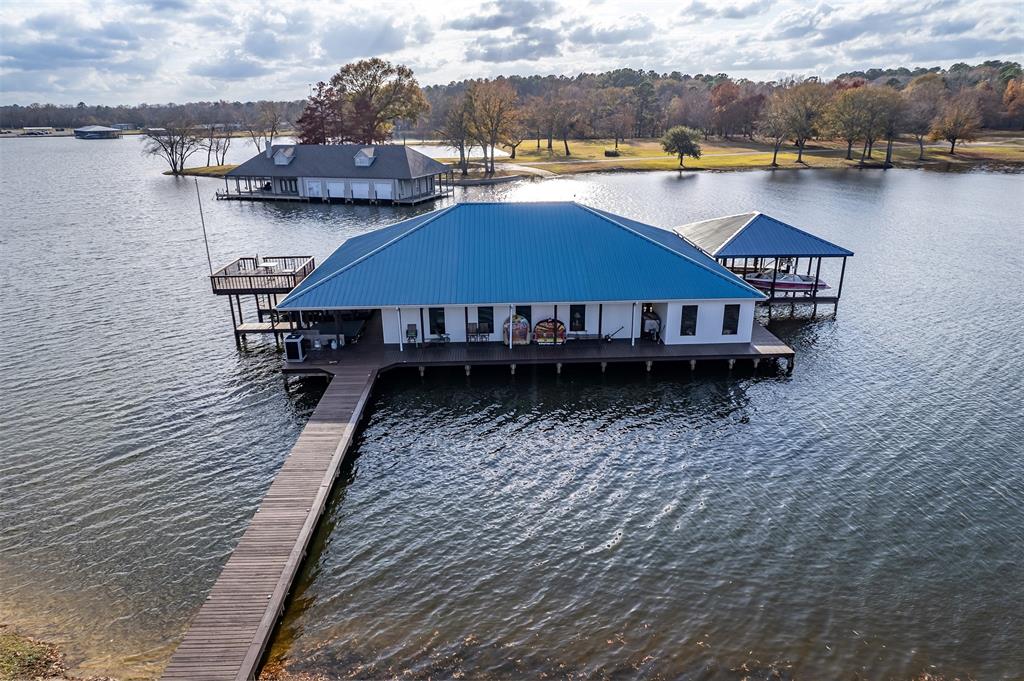 a aerial view of a house with wooden floor and lake view