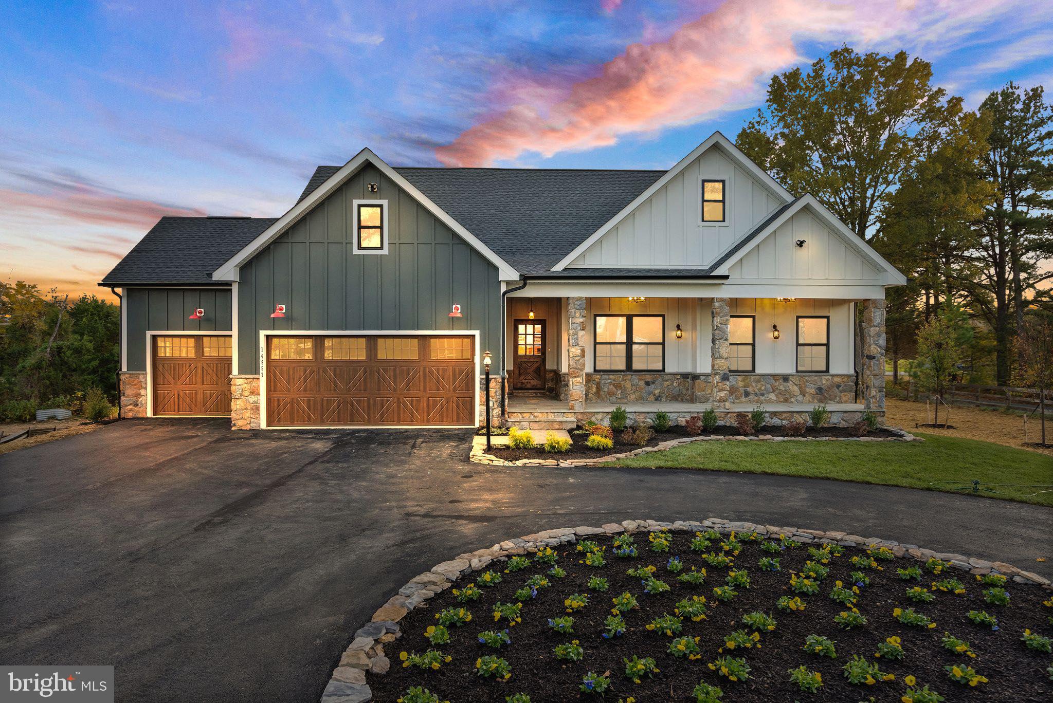 a front view of a house with a garden