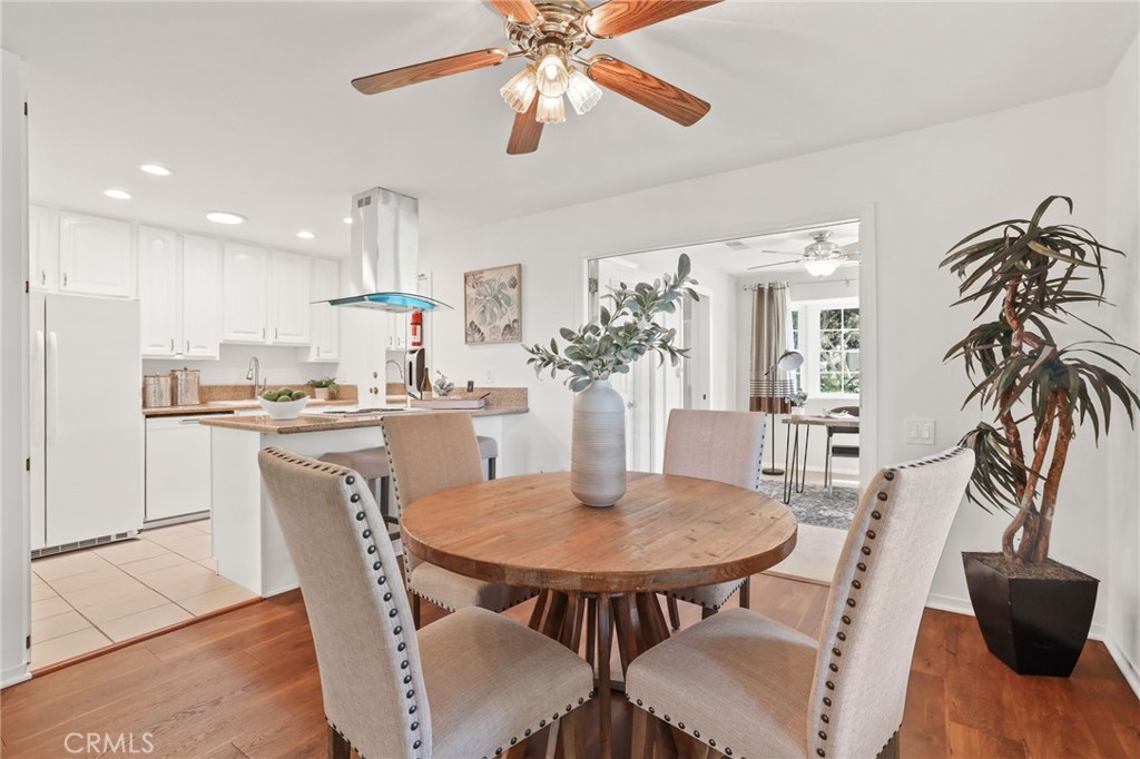 a view of a dining room with furniture and a kitchen