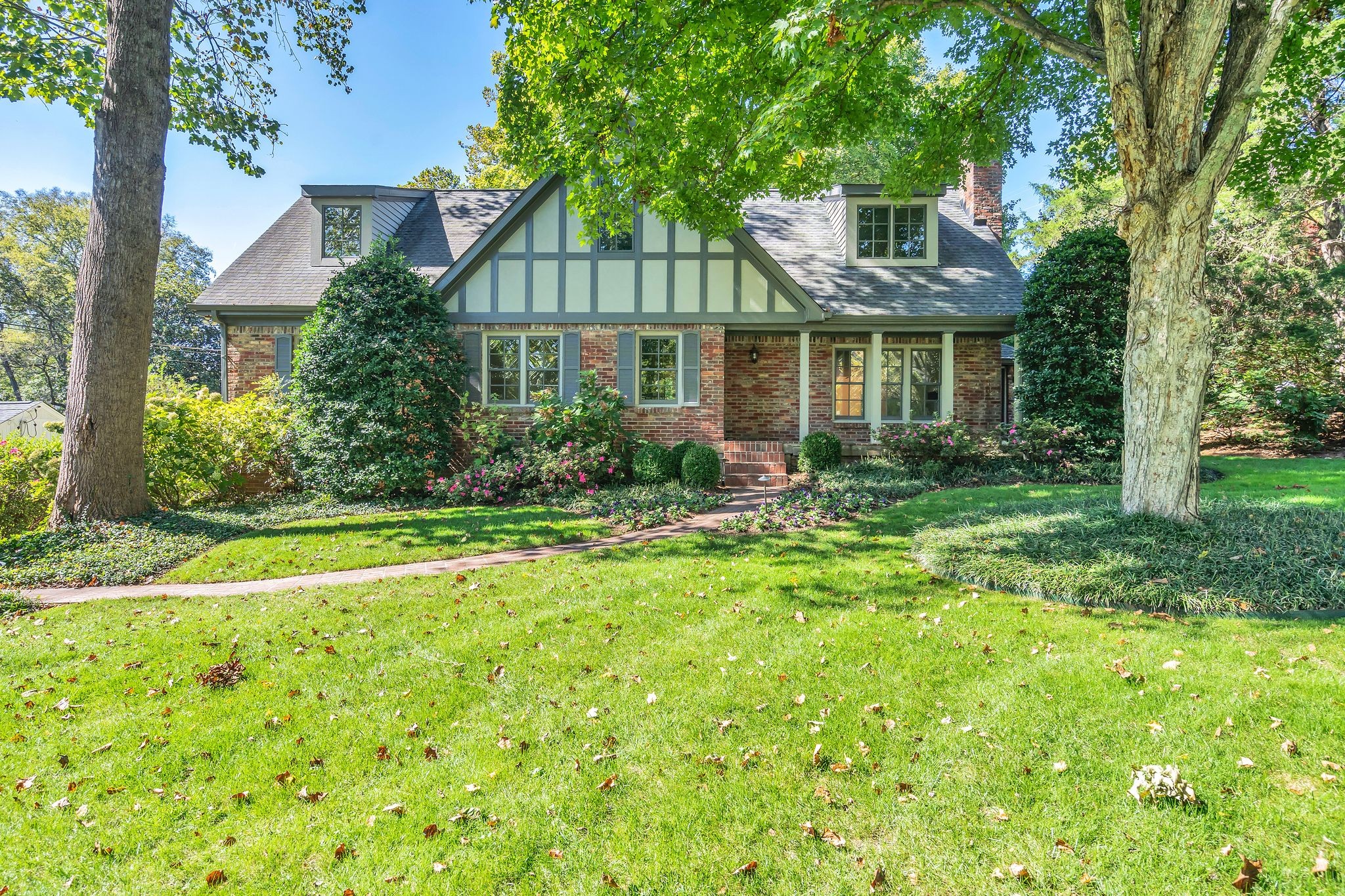 a front view of house with yard and green space