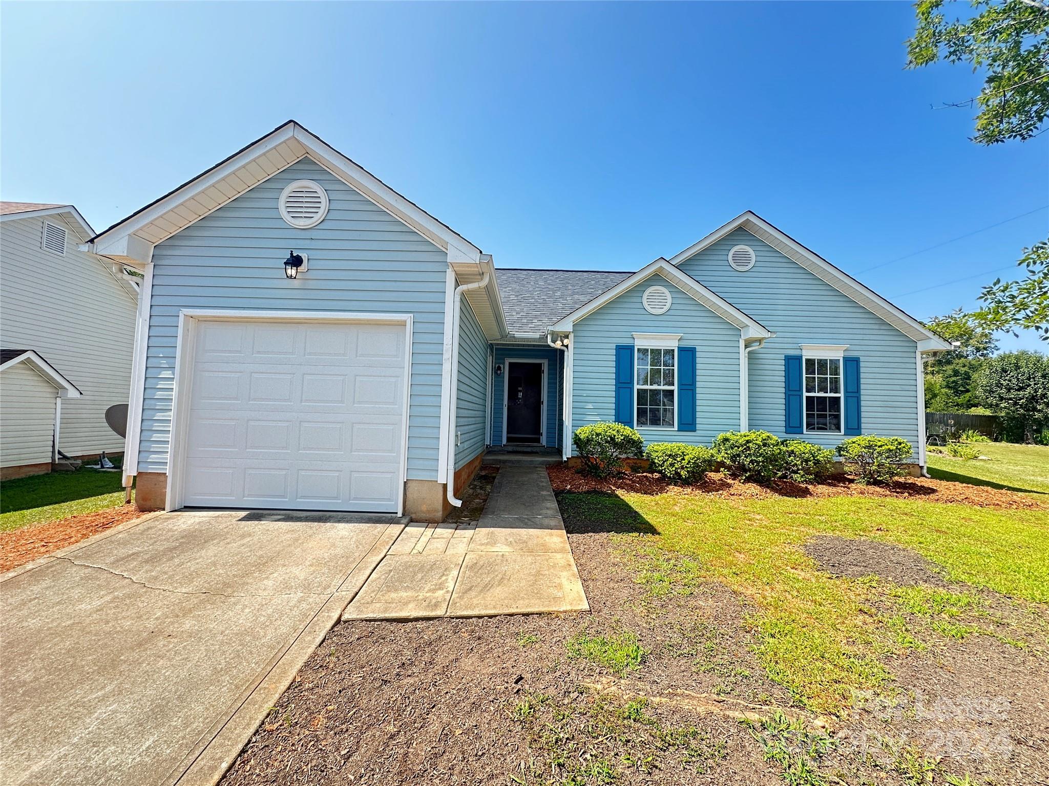 a front view of a house with yard and porch