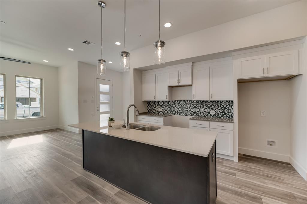 a kitchen with kitchen island a sink stainless steel appliances and cabinets