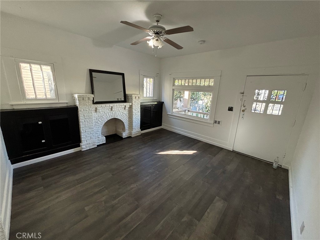 a view of livingroom and window with fireplace fan