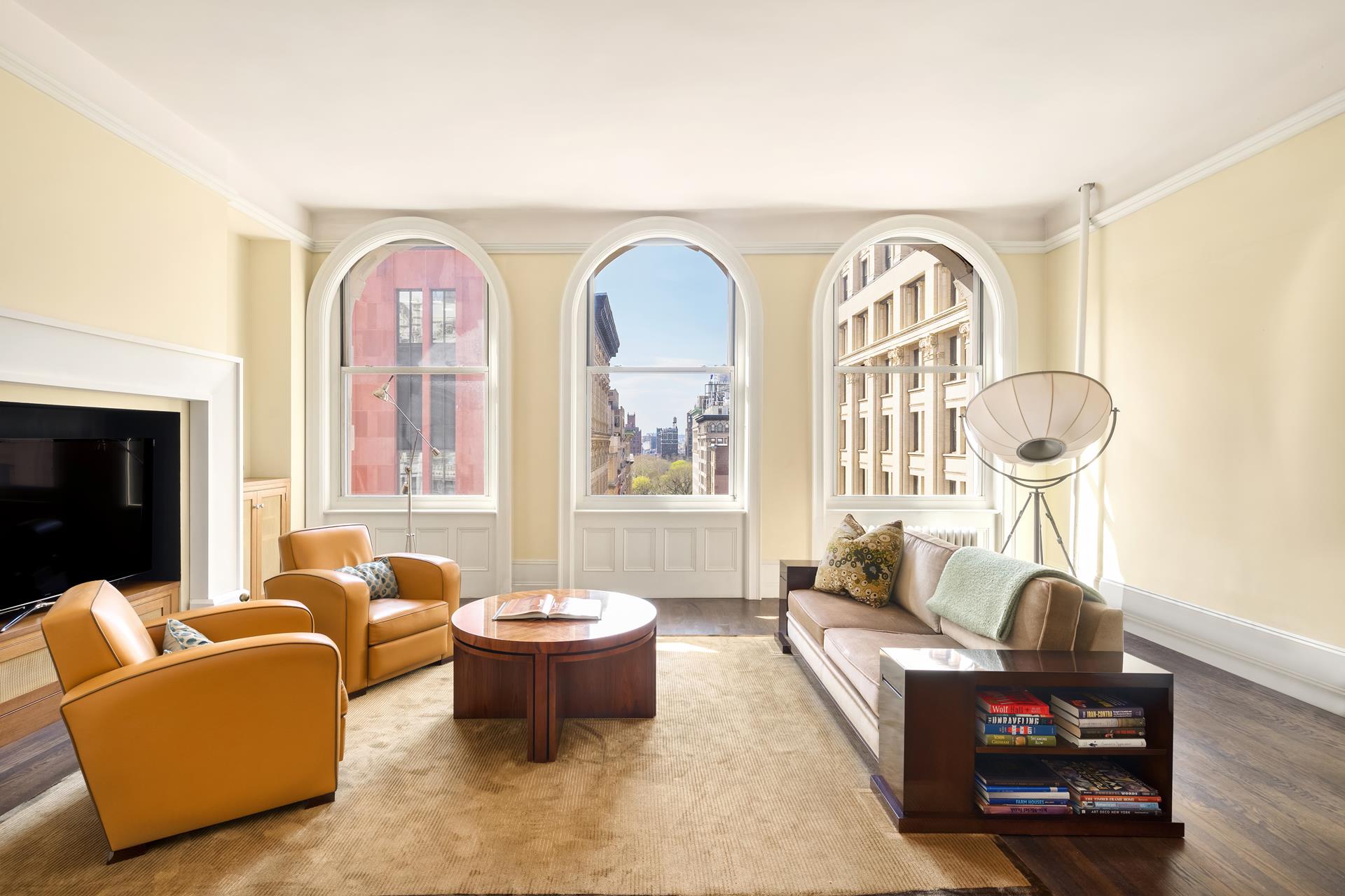 a living room with furniture two window and a fireplace