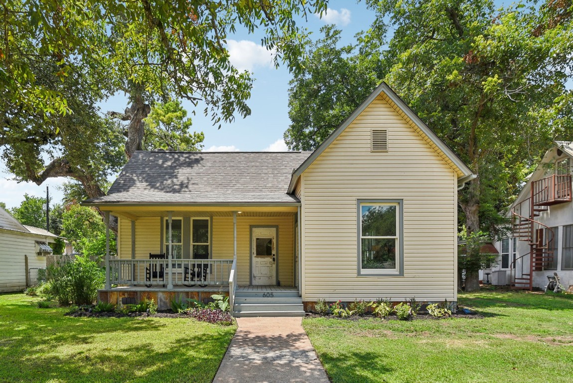 a front view of a house with a yard