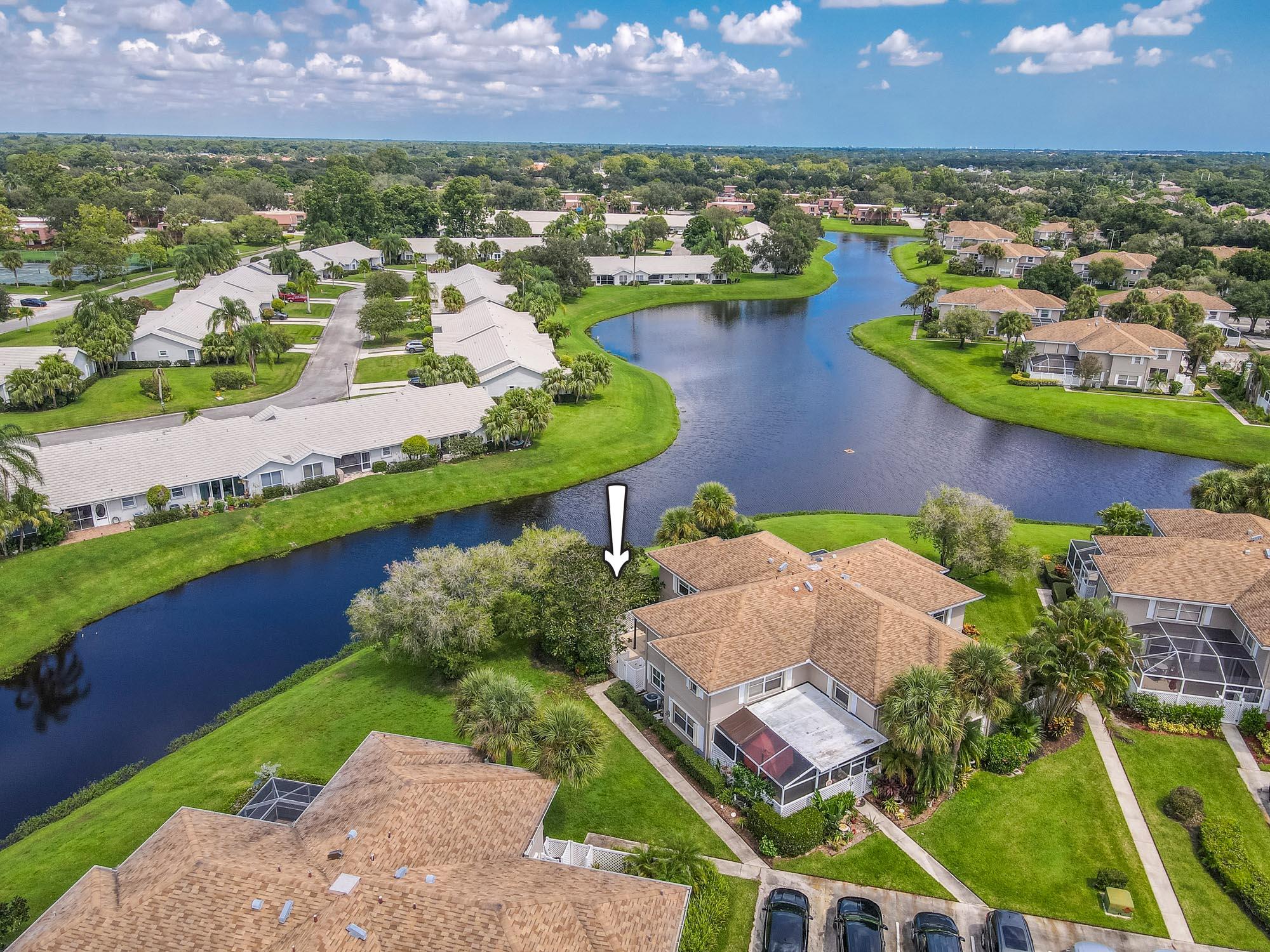 an aerial view of residential houses with outdoor space and lake view