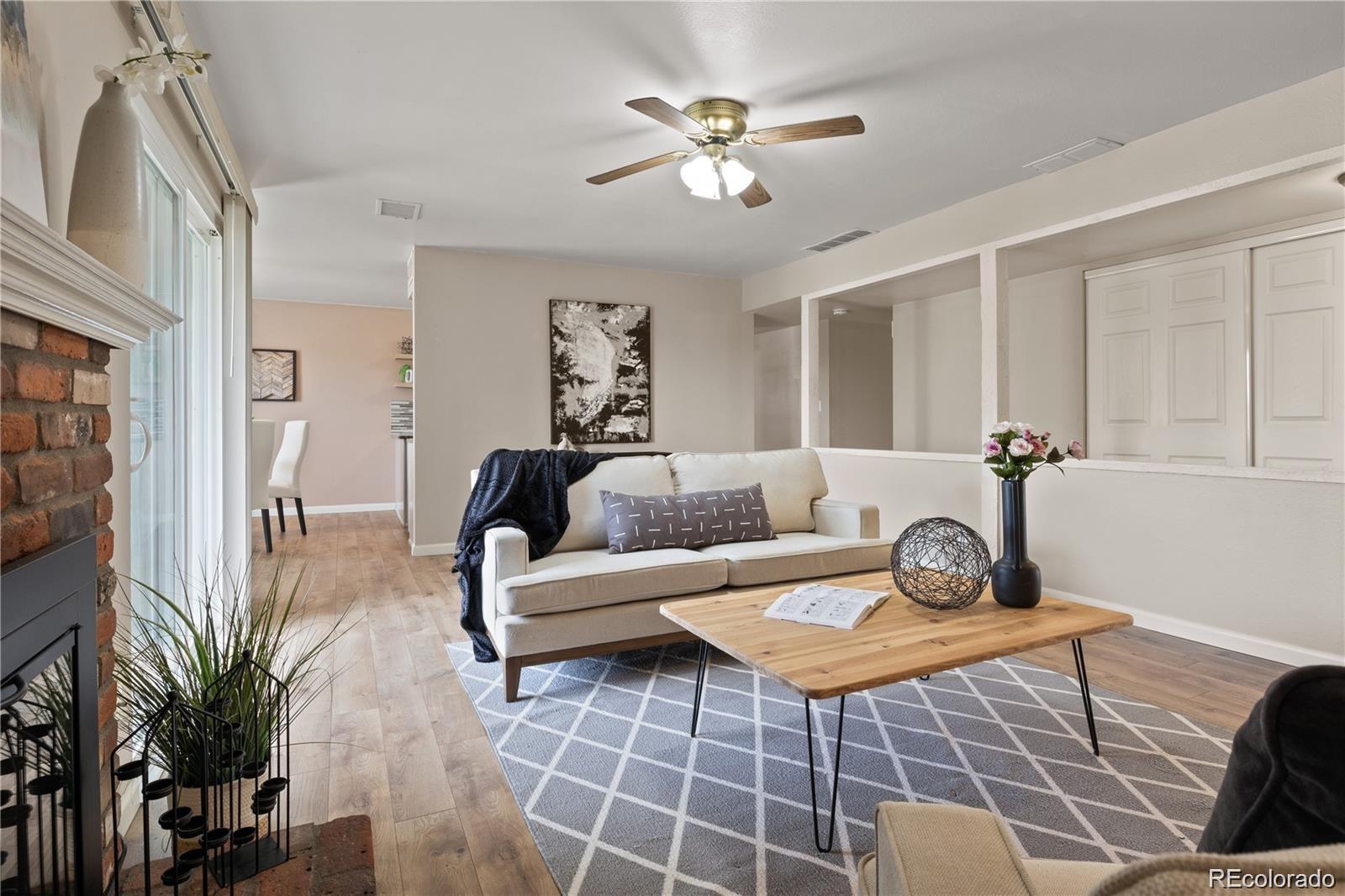 a living room with furniture a table and potted plant