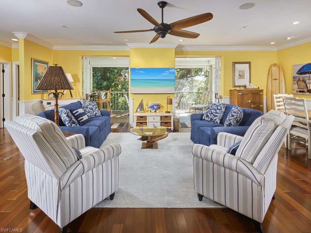 Relax in the spacious Great Room featuring hardwood flooring and access to the lanai.