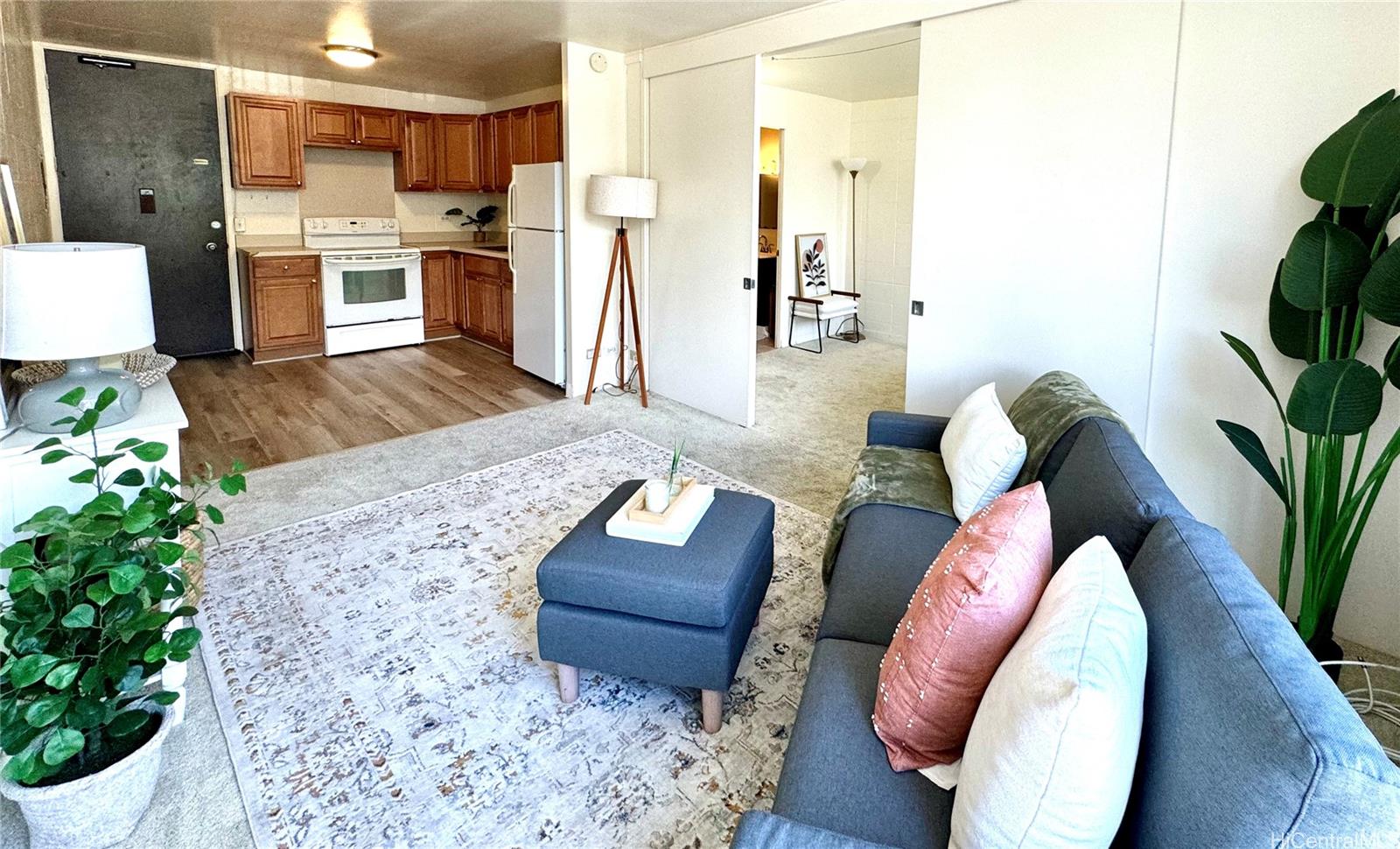 a living room with furniture and a kitchen