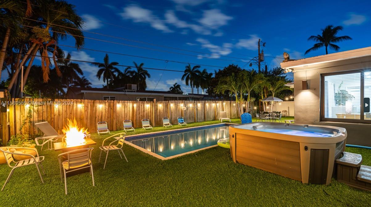 a view of a swimming pool with outdoor seating