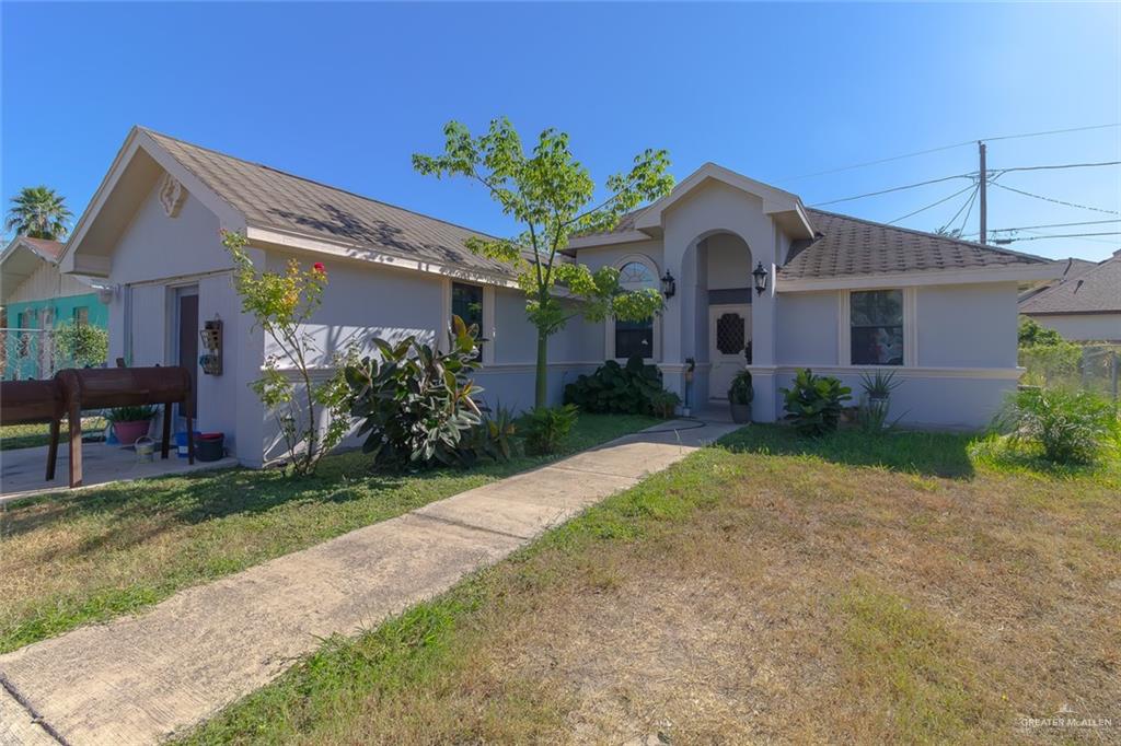 a front view of house with yard and green space