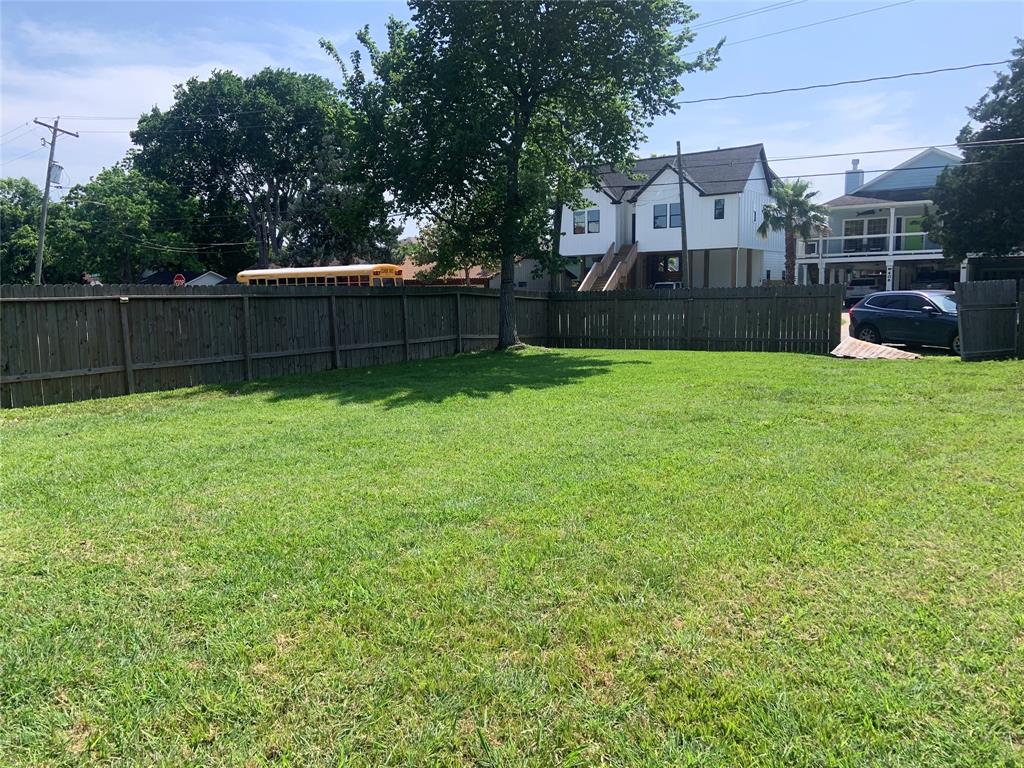 a view of a backyard with a garden and entertaining space