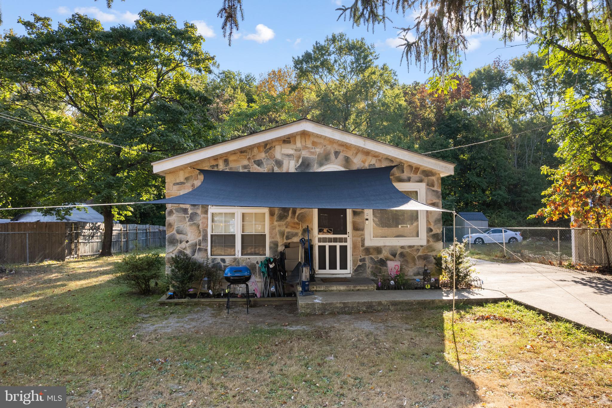 a backyard of a house with barbeque oven table and chairs