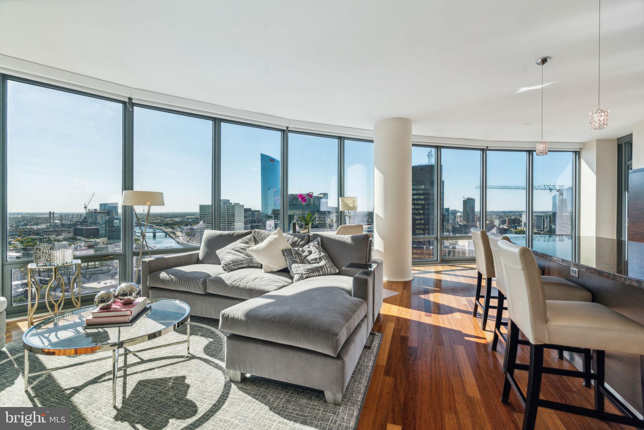 a living room with furniture and large windows