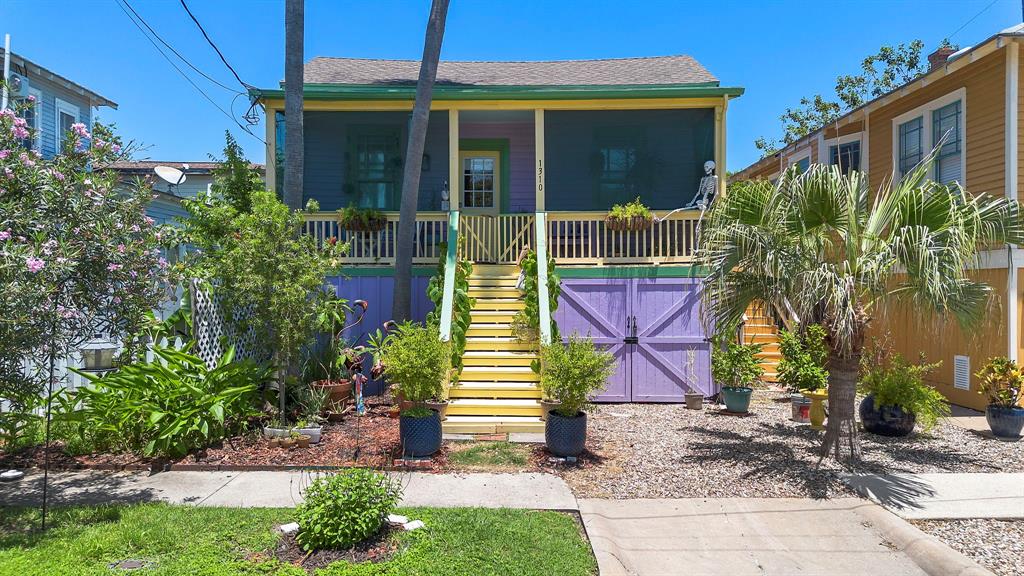 a view of house with a yard and potted plants