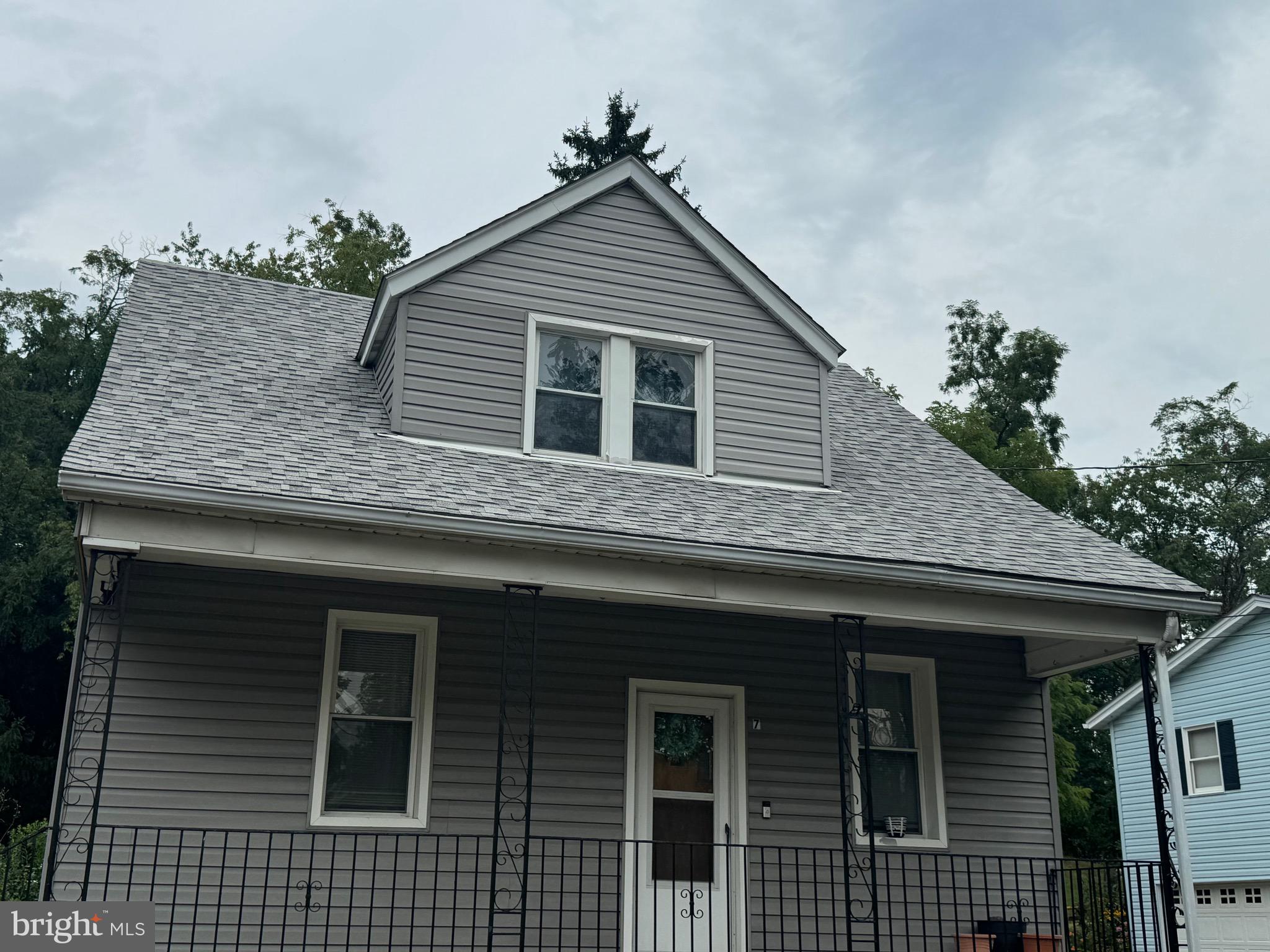 a front view of a house with plants