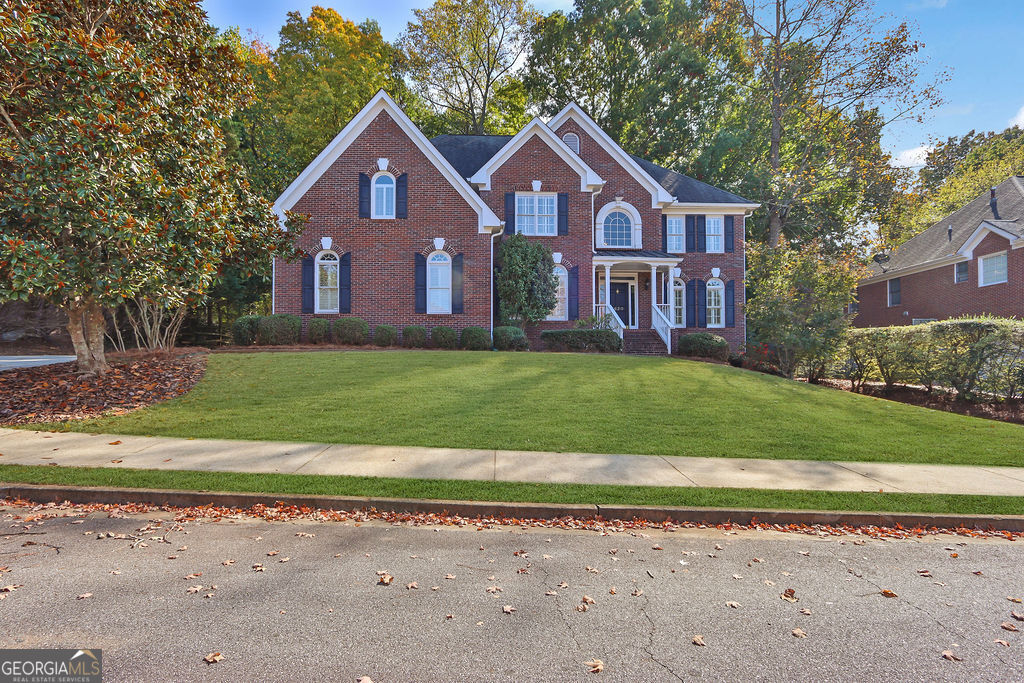 a front view of a house with a yard and garage