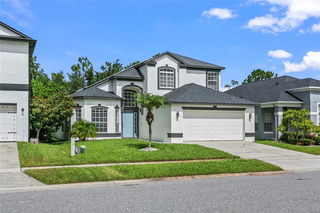 a front view of a house with a yard and garage