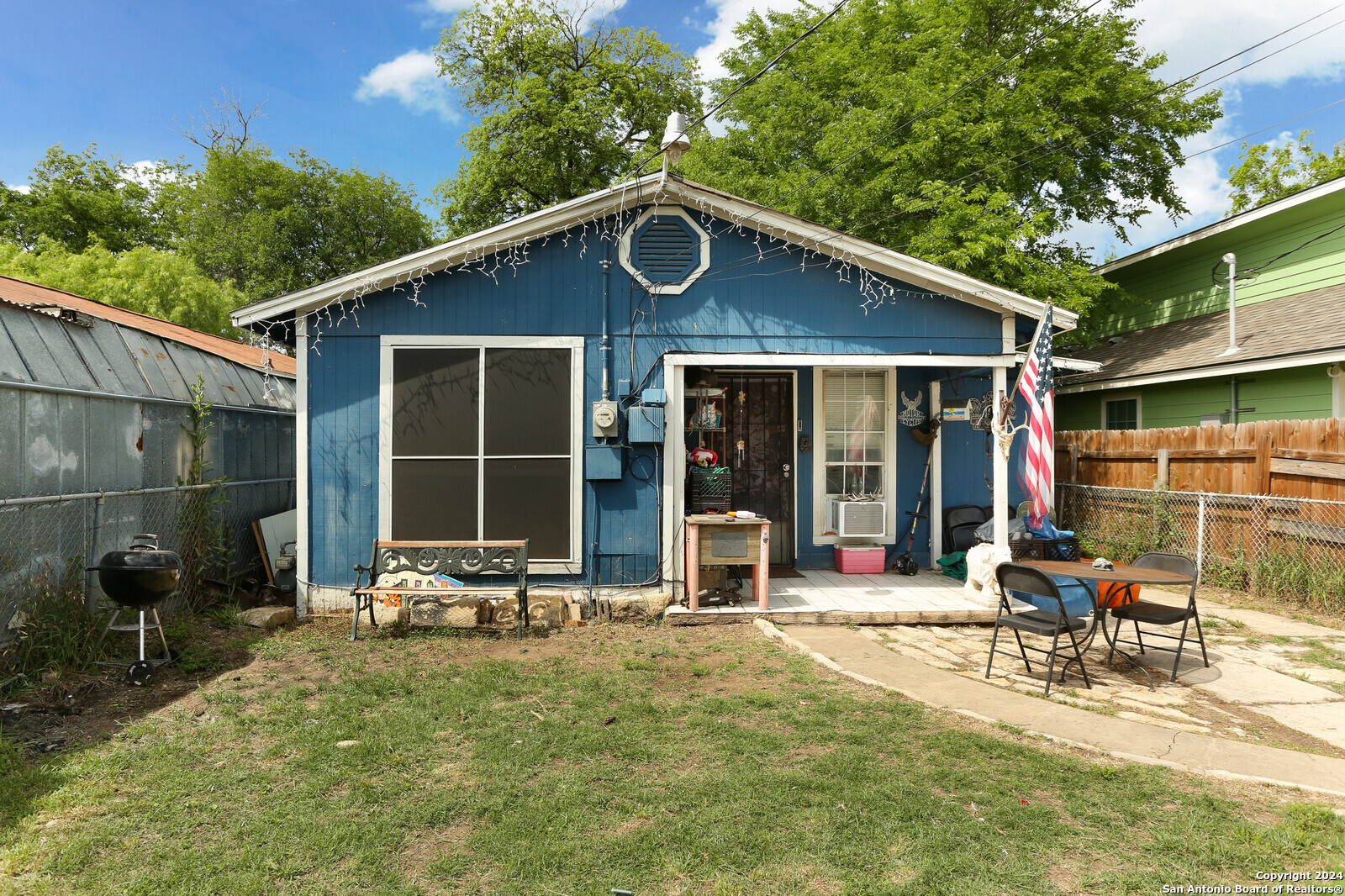 a backyard of a house with yard outdoor seating and barbeque oven