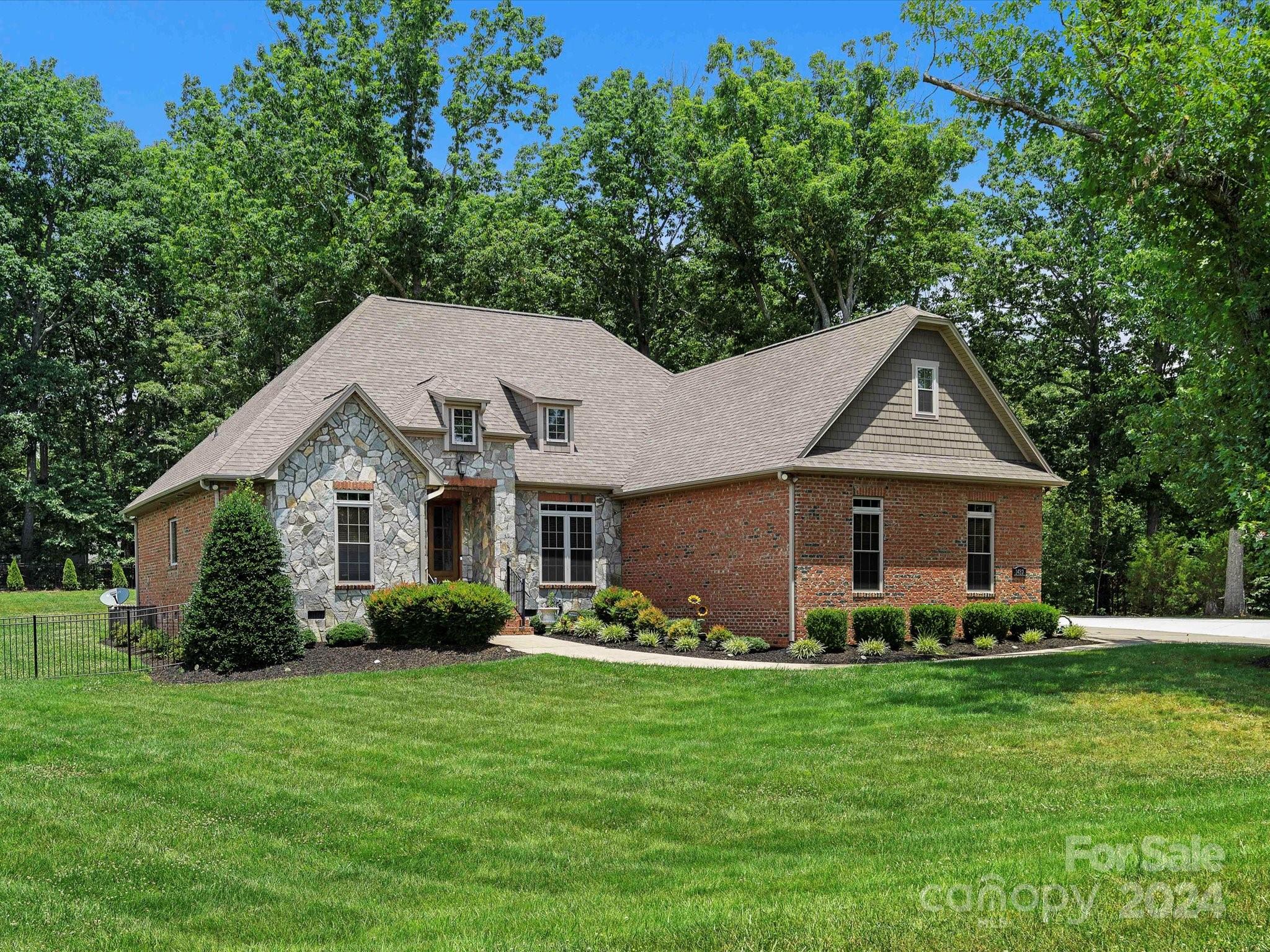 a front view of house with yard and green space