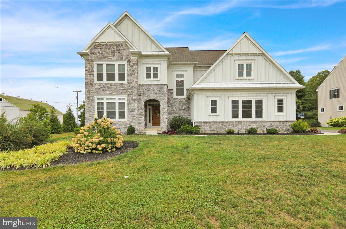 a front view of a house with a garden