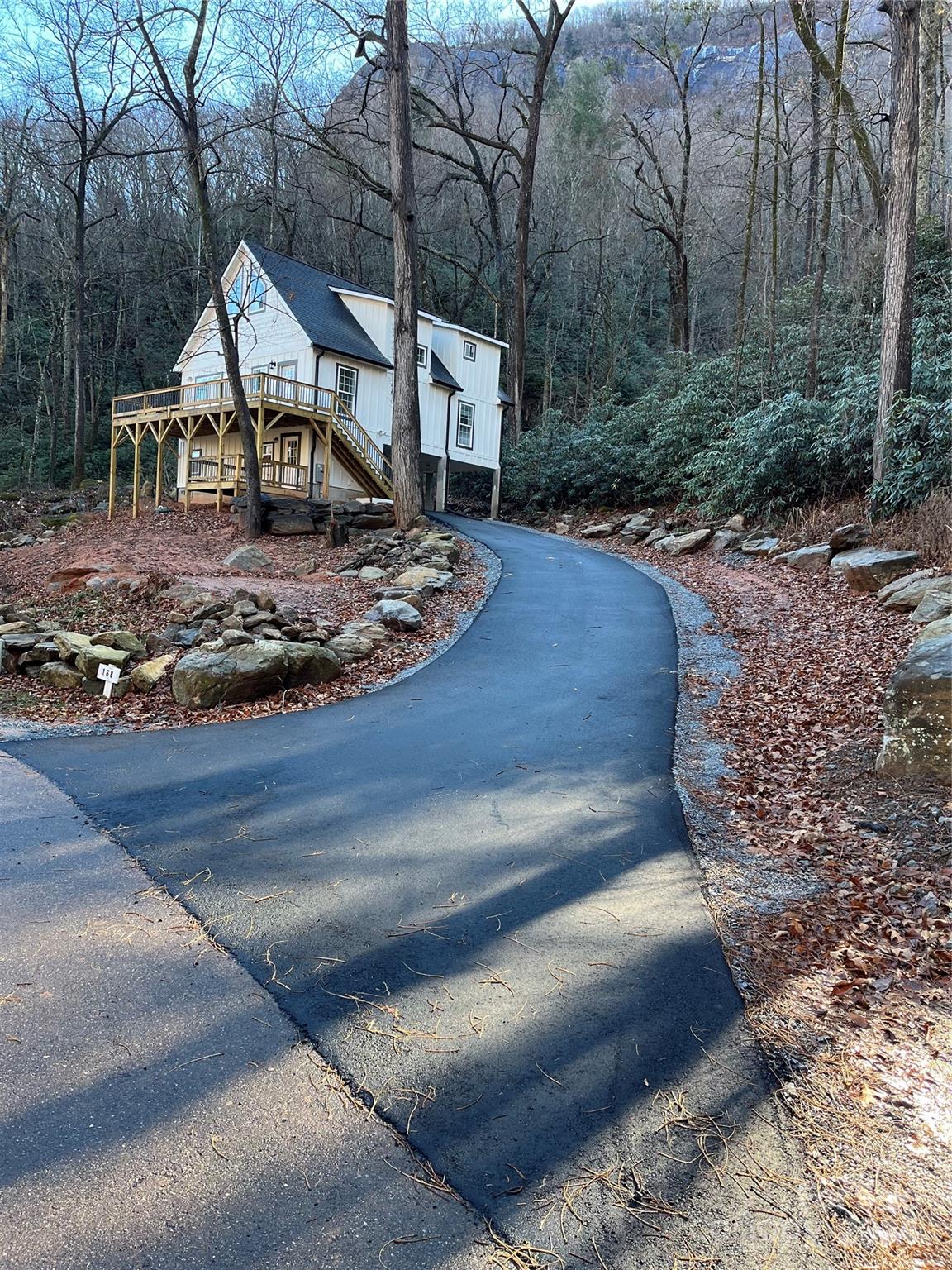 a view of a house with a yard fire pit and tree s